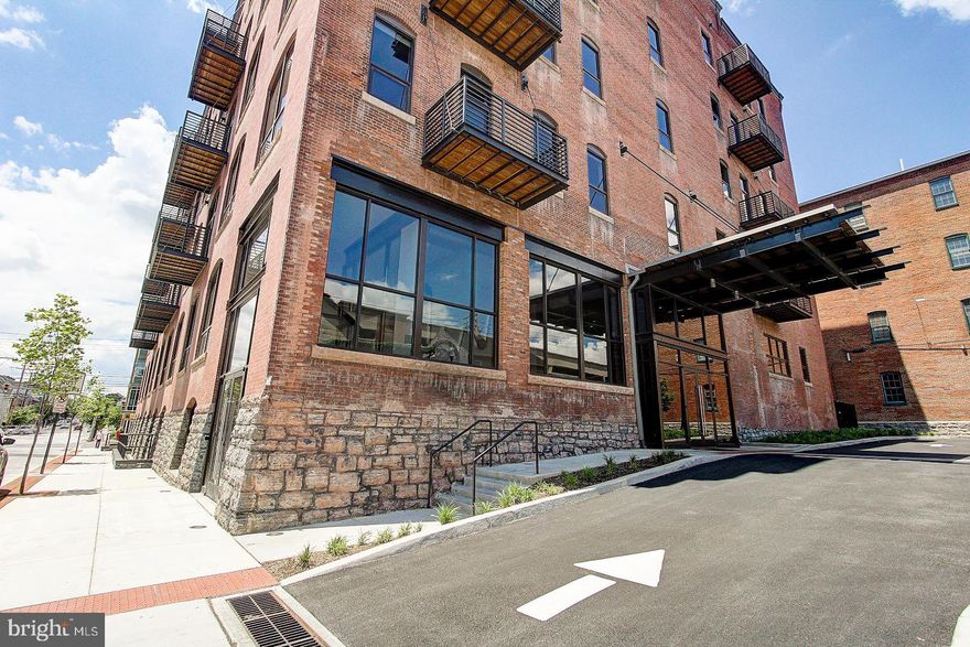 Beautiful 5th floor 2 bedroom, 2 bath condo in the historic Lancaster Press Building! Open floor plan with high ceilings, exposed brick walls & concrete columns. Kitchen features granite countertops, island, tile backsplash, under cabinet lighting and stainless appliances including gas range, refrigerator & dishwasher!  Hardwood flooring in foyer, kitchen and living room. Primary bath features shower with tile base & surround, glass shower door and tile floor. Stackable front loading washer & dryer. Relaxing rear balcony. Unit includes assigned parking space in secure & lighted adjoining parking garage on N. Market Street, and an assigned  storage unit in ground level. Monthly $300.00 condo fee included assigned parking, water, sewer, trash, gas for cooking, use of roof top deck & onside fitness center 24/7, and common area maintenance. Pet Friendly Building. EZ to show - quick possession possible!