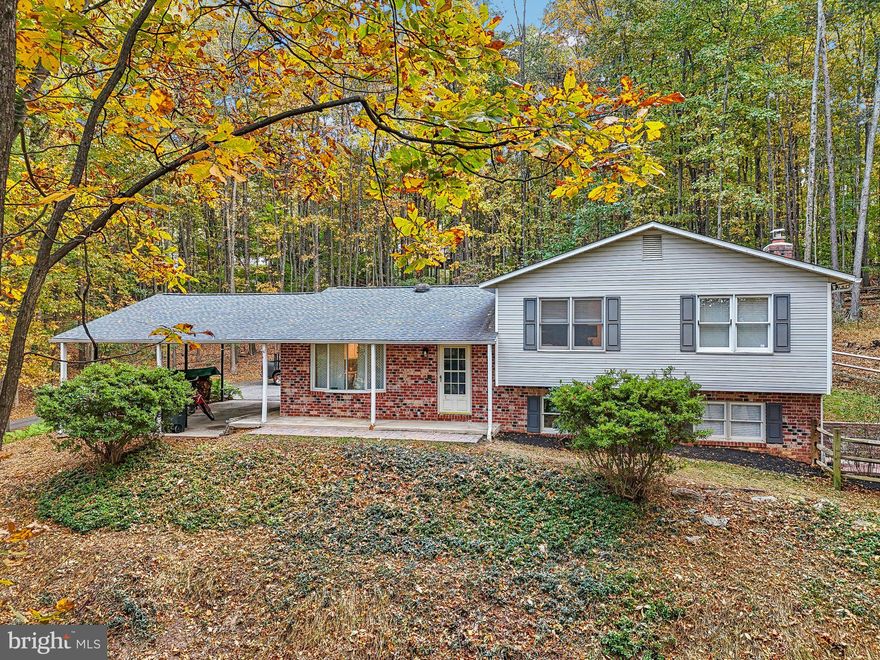 Tucked away on a serene, private lot surrounded by mature trees, this beautifully maintained 4-level split offers the perfect blend of comfort, space, and privacy on nearly 3 acres of wooded land.

Inside, you’ll find 3 spacious bedrooms and 3 full bathrooms, all accented by fresh, neutral paint throughout and updated luxury vinyl plank flooring that adds a modern touch with low-maintenance appeal.

The main level boasts a bright and welcoming living room and a dedicated dining room, perfect for entertaining or quiet meals. The kitchen flows conveniently into the dining area and overlooks the scenic backyard.

Down a few steps, the cozy family room offers a relaxing space to unwind, complete with large windows for plenty of natural light. An adjacent home office provides a quiet space for remote work or study. There's even a full bathroom on this level, adding extra functionality for guests or busy households.

Upstairs, the primary suite includes a private ensuite bath, while two additional bedrooms share another full bath.

The unfinished basement offers even more potential—create a rec room, gym, workshop, or storage area to suit your lifestyle.

Outside, enjoy the peace and quiet of your wooded retreat—ideal for nature lovers, outdoor entertaining, or simply soaking in the beauty of your own slice of nature. There’s plenty of space for gardens, a fire pit, or even a future outbuilding.

This is a rare opportunity to enjoy the space and seclusion of country living with all the modern updates you need. Located just minutes from major commuter routes, don’t miss your chance to call this unique property home!