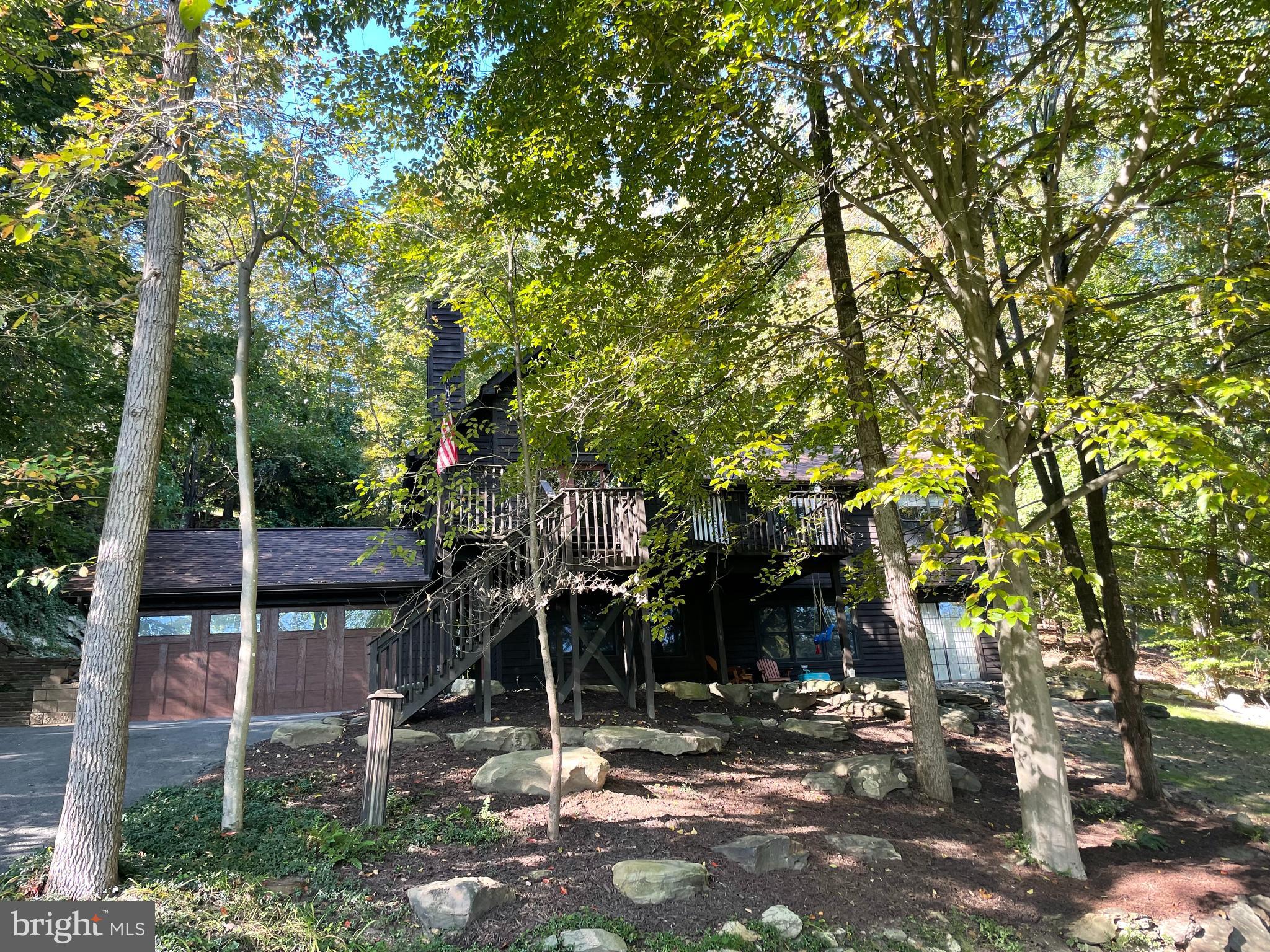 Perched precariously and confidently, in the woods of Lake Linganore, this five bedroom beauty is waiting for you! No typo, I said five bedrooms that pack a punch! Bring all the little people or even Grandma. Everyone gets their own space.
Enter into the great room and wow....A fully remodeled kitchen. This kitchen is beautiful and has it all.
Brand new wood plank flooring and built ins surround the tv area.
Lower level has two more bedrooms and living space, right off the garage area.
This tree house is calling for you, because what is better than being in the woods, hanging on your deck, watching the leaves fall and the lake glimmer? Oh I will tell you, a new roof! I mean it's not better but it certainly helps. Welcome home, to Balmoral Overlook and don't forget your bear spray....This home is located in Oakdale HS-A blue ribbon school!