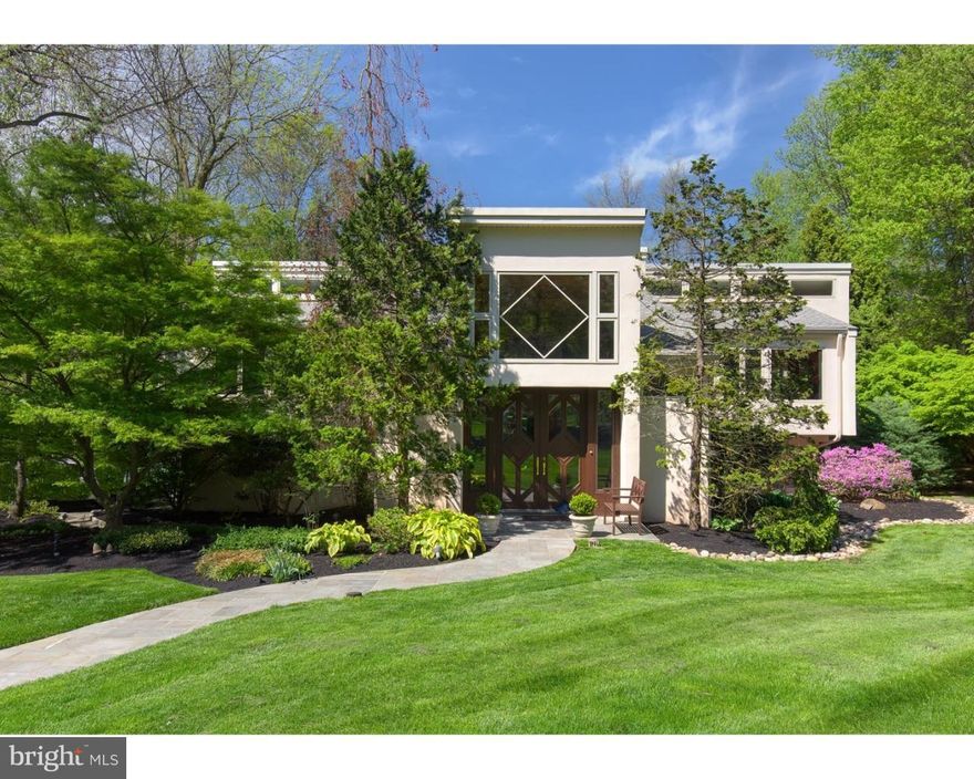 This stunning contemporary home is not to be missed! Custom built with dramatic architectural details, this home’s unique contemporary design is filled with light and space, and highlighted with a modern interior, vaulted ceilings, and an open floor plan. Skylights, sliding glass doors and walls of windows flood the rooms with natural light. Situated on an acre of pristine, landscaped grounds, the exterior spaces are an additional highlight. Relax on the rear deck overlooking a beautiful swimming pool and spa, and a Koi Pond tucked into a bed of decorative plantings adding to the idyllic, peaceful and zen environment. The 2-story entrance is welcoming with French marble flooring and coat closets. Move up to the main level featuring a spacious living room that overlooks the front entrance, has a vaulted ceiling and a wood burning fireplace with a marble surround. The adjoining great room showcases a cedar planked ceiling, built-in sound system,sky lights, an entertainment center,wet bar and glass doors to the deck. The wonderfully large cook's kitchen is highlighted by a vaulted ceiling, marble floor, skylights over the expanded center island with seating, and an ample breakfast area that opens to the deck. The top-of-the-line appliances include a Subzero refrigerator and freezer, Thermador double ovens, Meile dishwasher and 2 deep stainless sinks. The dining room has a wall of windows and a vaulted ceiling allowing light to flood the room. The main level Master Suite is spacious with a vaulted ceiling, skylight, hardwood flooring, 2 walk-in, custom designed closets, and a charming deck facing the rear yard. The lavish, spa-like master bathroom features a radiant heated marble floor, linen closet, his /her vanities and an expanded shower with both a rain shower head and a multi volume and spray patterned   heads, including a rain shower and handheld spray.  A Powder Room is also located on the main level. The ground level includes 4 nice sized bedrooms, 3 full bathrooms, an office / study, plus a spacious family room that opens to the rear yard and pool. The ground level is complete with a laundry room, utility room and entrance to the 2-car attached garage. Beautifully maintained, the 3 zoned heat pumps and 2 zoned central air compressors  have been replaced. Included as well is a generator and expanded irrigation system This home is a joy to live in, fabulous for entertaining, and the enjoyment of the privacy resulting from the exquisite landscaping. Located on a coveted street in Bryn Mawr, the home is also in the award-winning Lower Merion School District.