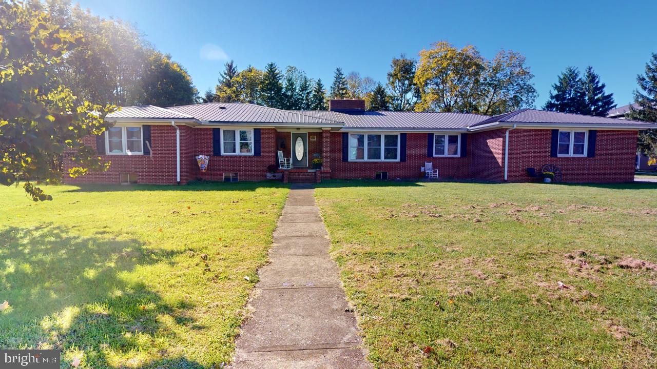 Moments away from all the conveniences of town but tucked away out of sight, sits this stunning 2,758 square foot brick home on 1.9 acres. The beautiful woodwork upstairs adds a very elegant touch to the dining, living, and family room. The living room has a stone fireplace with a wood mantel, just waiting for your decorations. The family room has double doors that open to the patio, where you can enjoy the evenings outside. The kitchen has Corian countertops with ample storage space, and a built-in bar. 4 bedrooms and 2 full baths upstairs, means room for the entire family. The main bedroom has 3 walk-in closets with an attached full bath. This home provides the ability to live on one floor but offers an additional 2,758 square feet basement that is 75% finished! The basement includes a huge family room with a brick fireplace, a half bath and a bar area. The unfinished portion has plenty of storage for all of your belongings. Don't miss your chance at this beautiful home in WV within the city limits of Petersburg!