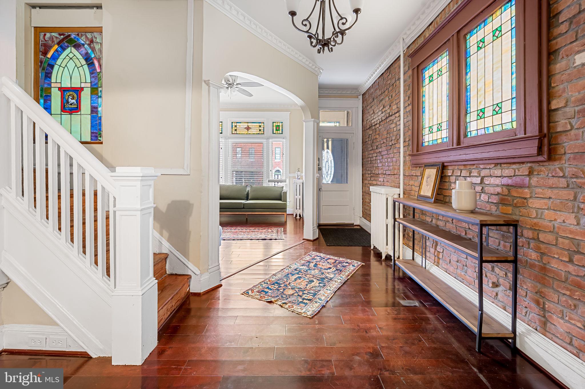 Another special Reservoir Hill find! This spacious and lovely house with period detail is located in a Reservoir Hill historic district just blocks from the Druid Hill Park and Reservoir -- an area of Baltimore City that is currently being re-vamped with outdoor offerings that enhance this buzzing neighborhood. The 9+-room house includes 4 bedrooms and two additional "pass through" rooms that await your creative application to enhance the others -- to serve perhaps as nursery, office, closet, suite bathroom, exercise, den, or guest room. The central staircase reflects period detail and a myriad of stained glass enhances the first-floor porch, center hall and stairs, living room, and dining room. The second floor rooms are large including three bedrooms, a bathroom, and a "pass-through" room. The third floor is charming as it has a door that creates a private suite with two rooms and a bathroom that would be wonderful as a private au pair or guest suite. The rear yard is spacious awaiting your enhancement and looks onto the rear of three lovely adjacent homes and their yards, one of which is a double-property home with spectacular landscaping. High ceilings complement all space throughout the house. The kitchen requires renovation; house has no central AC; owner does not want to make improvements. With tailored renovations and enhancements, this is your opportunity to create exactly the home and its amenities that you imagine would be ideal. The adjacent home 2411 Madison recently sold for $540,000. Come take a look!