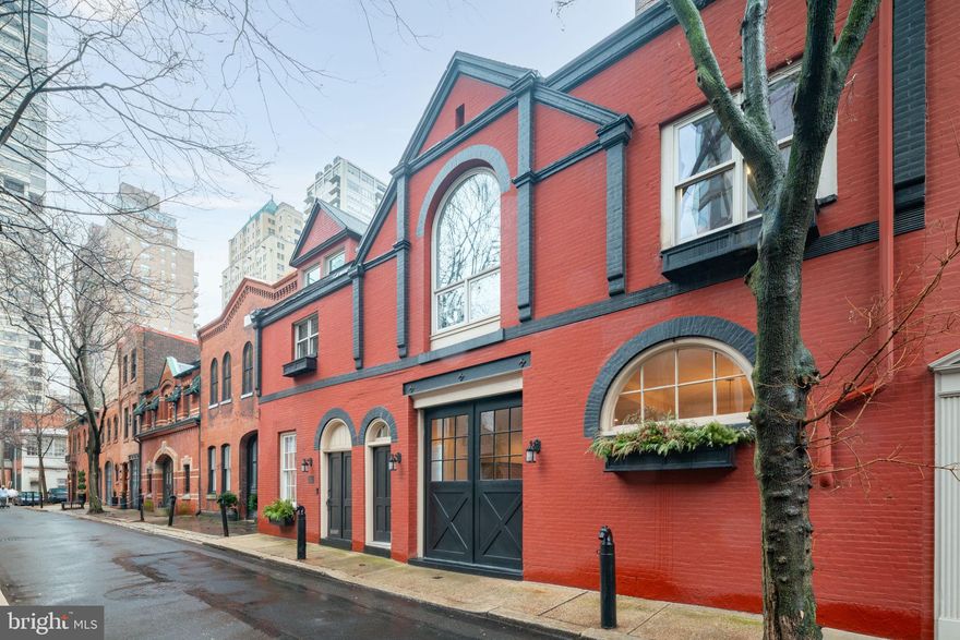 Stunning HISTORIC 19TH CENTURY CARRIAGE HOUSE with GARAGE PARKING. Dramatic property, in impeccable condition with an exceptional facade. A lovely melange of contemporary design and original details with 45' frontage on a picturesque, tranquil street, steps from Rittenhouse Square. Exceptional natural light from both Northern and Southern exposures. Completely renovated with substantial improvements by current owners (list in Seller's Disclosure). This unique property has approximately 3,900 Square Feet: 4 bedrooms, 3 full and 2 half baths. In addition, a large study/sitting room with 16' ceilings and finished basement. Wood floors, recessed lighting and high ceilings throughout. Access on 1st floor to an oversized 1 car garage. Large entry foyer leads to huge open plan living room, dining room and kitchen. Spacious custom kitchen has 36" Wolf gas range, Sub Zero refrigerator, Sub Zero wine refrigerator, Asko dishwasher, spacious white Shaker-style cabinetry and slab Carrera marble counters. Large center island with marble waterfall edge. Gas fireplace, powder room and coat closet. The second floor is comprised of a large primary bedroom with en-suite bathroom. There are double closets and custom built-in storage. The bathroom has a double sized glass-enclosed shower, separate soaking tub, double vanity and marble tile. This floor also has a central, large open living room/family room and wet bar with a dramatic arched window and vaulted ceiling. There are 2 additional bedrooms, two full mosaic tiled baths and a laundry room with a washer and dryer on this floor. The 3rd floor has the 4th bedroom, two large closets and a roof deck. Full finished basement with exercise room, sitting room, wet bar, half bath and additional storage.
