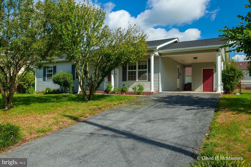 Cozy as every ranch style home has been refreshed throughout with paint, bathroom updates, and some new lighting fixtures!    Traditional rancher floor plan offers 3 bedrooms, 2 baths, covered front porch, and car port with extra storage.  Entertain friends from the fire pit with built in seating and floating deck accessed from the eat in kitchen.  Rear yard offers a flat and fenced area perfect for your furry friends!  You will find this home tucked on the outskirts of Martinsburg on a cul-de-sac street, but just moments to in-town convenience and easy access to shops, restaurants, and medical facilities. A complete home package offers a newer roof and water softener and a one-owner home that has been lovingly maintained since 1990.