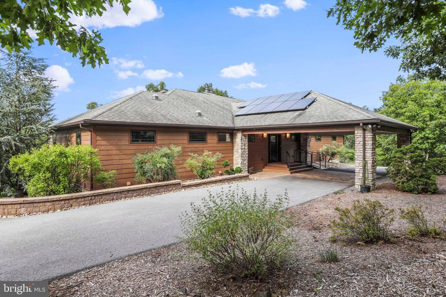 STUNNING!! Home situated on 1.1413 Acres, with an adjoining 1.21 Acre Lot for a total of 2.35 Acres in the prestigious Cacapon South community.  As you approach the home on the paved, circular driveway, you are welcomed by a large porte cochere at front door for protection from the elements when entering or exiting the home.  Wheel chair accessible ramp to the front door leads to a spacious foyer.   Half bath for guest off the foyer and well as a roughed in optional elevator shaft that can also be used for storage if you choose not to install an elevator.  Walking into the main living space provides an open kitchen, dining and living room floor plan, perfect for entertaining guests.  Spacious pantry off kitchen as well as a separate area with  bookshelves for cookbooks.   Owners suite features an adjoining Bathroom with soaking tub and separate shower.  There is access to a large walk in closet from the owners bathroom as well as access to a laundry room.  Second Bedroom  with adjoining bathroom is off the kitchen and third bedroom is currently being used as a second office.   Spacious screened porch for hours of relaxing  and an office with windows on 2 exterior walls with mountain views makes the work day more enjoyable.  Finished lower level with an open floor plan features a family room with a gas fireplace, exercise area, dining area and kitchenette.  Bedroom 4 & 5 complete the floor plan, each with an adjoining bathroom as well as several storage rooms .  2 car garage with an electric vehicle charger.  Paved driveway circles the home with level, walk-in access to the lower level, making  a perfect separate living space for an elderly family members or guests.   Lower level floors (including the garage) have radiant heated floors.  Forced air heat and AC ducts in the garage ceiling for future vents to expand living space.  3 Geothermal wells in the front yard provide the radiant heat in lower level.  36 solar panels on the roof and an emergency propane generator that serves most of the home.   All this and less than a mile from Cacapon Resort State Park, offering  6115 acres of outdoor activities, including golf on their 18-hole Robert Trent Jones golf course, swimming in the lake, paddle boats and canoeing, horseback riding, skeet shooting, playground, newly resurfaced tennis courts, paved basketball court or sand volleyball court and  vacation cabins. Two areas at the park, the lake and reservoir, offer fishing opportunities. The lake is stocked in the spring for trout fishing, but other fish that can be caught are bass, catfish and blue gill. The reservoir is not stocked.  The lodge, along with a restaurant, extend first-class service year-round, with a recent  expansion to the lodge,  increasing the room inventory by 80 additional rooms a fitness area, expanded food service, sauna and indoor/outdoor pool, as well as some golf course improvements.