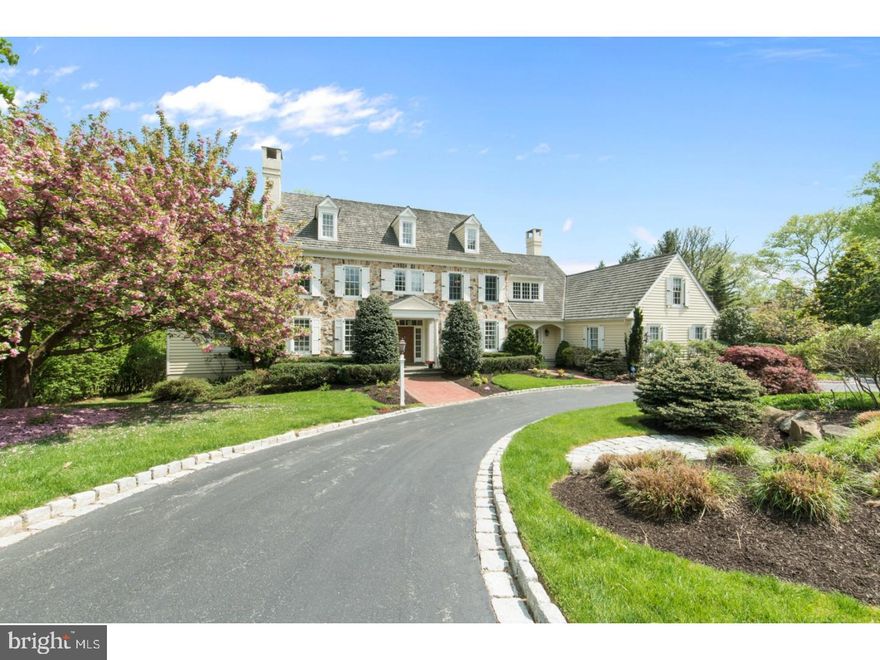Elegant and thoughtfully designed by Visich Architects, this gorgeous Stone Colonial is perfectly situated in the Sought after community of Harriton Farms, a development w 54.9 acres & walking trails. This home is ideally set on meticulously manicured grounds, and backs up to acres of preservation/open space for complete Privacy & breathtaking views from every window. Sunlit Open Floor Plan w Luxurious First Floor Master Suite, Walls of Windows create unbelievable Sun drenched interiors, soaring Ceilings, dramatic arched doorways, deep silled windows, extensive use of detailed moldings & wainscot, beautiful Hardwood Floors throughout, New Designer Fixtures, imported Marble & Granite. Belgium block lined circular drive leads you to the Grand double door two story entrance Hall with sweeping staircase open to the Formal Living room w marble surround FP, and Spacious Formal Dining Room w adjoining butler pantry. Gourmet Custom Kitchen w white Maple Cabinetry, Granite Counters, Seated Island, Stainless appliances, dual Thermador convection ovens, New Sub Zero Refrigerator. Kitchen is open to the sun-drenched Breakfast Rm and Great Room w vaulted ceilings, walls of window, Floor to Ceiling Stone gas FP, French Doors open onto the spacious flagstone terrace overlooking the picturesque acres of preserved grounds, perfect for Outdoor entertaining & alfresco dining. Master Suite w Tray ceiling, his and her custom walk-in closets, newly refreshed spa like Marble master bath w deep Soaking tub, walk-in shower, double vanities w custom built ins. Master Suite has french doors to an attached Cherry Paneled Study w walls of windows & custom built in bookshelves. The sweeping staircase leads you to the second level with 3 Large Bedrooms & 2 Full Baths w Granite Topped Vanities and soaking tubs. Additional storage area (space to create another bedroom suite) & cedar closet on this level. Day-lit Lower Level features Au-Pair & In-Law Suites, Media, Game Room, Office, Massage Room, Gym & Full Bath. Additional Highlights: Whole House GENERATOR, Oversized(3)Car Garage, Freshly Painted Interior. Award winning Lower Merion Schools, 2 miles to Center of Bryn Mawr(train, shopping, restaurants, Starbucks). This exquisite REFRESHED home feels "NEW" and is perfect for Comfortable Family living & Grand-Scale entertaining.