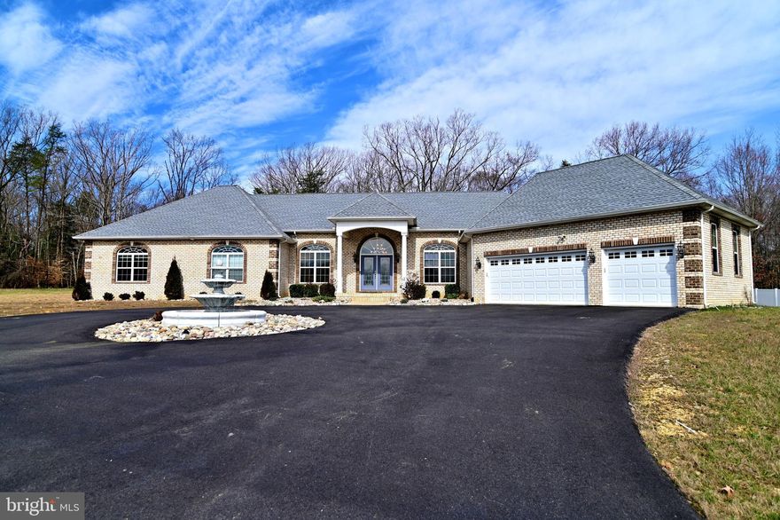 This custom built Poindexter model is a stunning contemporary all-brick rambler on 3 acres of land that offers main level living of a spacious foyer that opens to a family room w/fireplace, living room, main dining area off  kitchen with table space nook, energy-efficient appliances, 2 sky-lights, and a 20x20' deck.  Right side of home offers two in-law type bedrooms w/jack&jill full bath.  Left side of home offers two more bedrooms, full bath, and a gorgeous main bedroom suite w/ walk-in closets, full bath w/soaking tub, walk-thru shower, and sitting area.  There is also a library/study, half-bath, and laundry room off 3 car garage on main level.  Full size partially finished basement offers finished theatre room, bedroom, full bath, sump pump, tankless water heater, etc.  Unfinished area suited for future recreational rooms and plenty of storage.  NO HOA FEES.