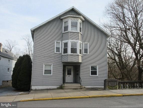 KUTZTOWN STUDENT HOUSING - Incredible opportunity to purchase a well maintained 4 unit building just minutes from Kutztown University. 7.14% Cap Rate. 12.21% Cash on Cash Return. Property consists of four apartments licensed for 11 students with 11 individual bedrooms, common area, laundry room, off street parking for 13 cars and 3 oversized garage bays. All apartments have one full bath. 0ne 2 student apartment and three 3 student apartments. Landlord pays water, hot water, sewer, taxes, insurance, basement and laundry area electric. Tenants pay for electric, trash, cable and internet (all apartments are electric baseboard heat). 5 meters, one for each unit plus landlord meter. New improvements include new vinyl siding on building (2024) and new roofs on building and two garages(2024) water heater (2019)and $58k addition of two bedrooms to unit 4 apartment to increase total student permit from 9 to 11 bedrooms (2013). All appliances are included in the sale. Centrally located next to Turkey Hill and within walking distance to downtown dining & shopping. Great rental history. Additional rent from summer occupancy and garage rental.