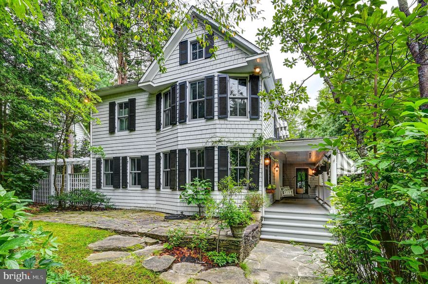 Quintessential Ruxton Charmer.   Step into timeless charm with this welcoming 1903 shingle style cottage, where character and comfort blend seamlessly with thoughtful updates.  A delightful awning covered porch invites you into gracious living spaces filled with  dappled natural light thanks to the well maintained mature landscape.  Living and dining rooms are complete with wood burning fireplaces.  A cozy den with built ins and bay windows is the perfect spot to relax.  The well appointed kitchen, with Wolfe range and Sub Zero refrigerator/freezer, is drenched in sunlight and provides one of two access points to a spacious deck, the second being a welcoming and light-filled family room.  Down the deck steps find a lovely native plant garden and the former garage, known as the "Nook" - which now serves as a fair weather getaway and exercise spot.   The second floor provides 4 bedrooms and two full baths, including the ensuite primary with fireplace, vaulted ceilings and skylights.  A lower level bedroom/office with full bath opens to the back garden and a covered lounge space - for relaxation and privacy at once.  Every window and exterior door has been replaced.  Roof is approximately 12 years old. Hardscapes by European Landscapes and Design.