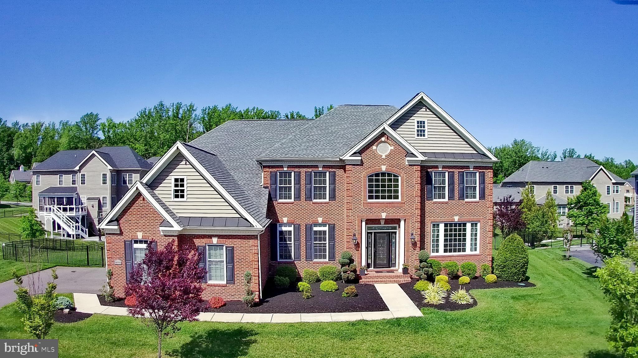 *** IMPROVED PRICE *** NEW PICTURES *** Welcome to this exceptional Toll Brothers custom estate, located in the prestigious and amenity-rich Oak Creek Club, a gated community in Upper Marlboro. Offering over 7,300 sq. ft. of luxurious living space, this home combines sophisticated design with unmatched functionality.
Upon entering, you’re greeted by a grand two-story foyer with a dual sweeping staircase, with stunning views from the second floor. The main level features custom millwork, coffered ceilings, engineered hardwood floors, and designer lighting, creating an elegant atmosphere throughout. Ideal for both entertaining and daily living, the home boasts formal living and dining rooms, an executive office, a 3-season deck, and a striking two-story family room with a dramatic fireplace and custom lighting.
The chef’s kitchen is the heart of the home, with GE Monogram stainless steel appliances, custom granite countertops and backsplash, a large island, 6-burner gas range with oven, second oven and microwave are built-in, all cabinets have end-panels and walk-in pantry. The kitchen flows seamlessly into a cozy breakfast area and offers direct access to the laundry room with Samsung appliances, cabinetry, and sink and access to the mudroom and garage access.
Upstairs, the primary suite provides a serene retreat, complete with a sitting room, dual walk-in closets, and a spa-inspired en-suite bath featuring a soaking tub, separate shower, water closet, and dual granite vanities. The home also offers an additional suite with en-suite bath, two more bedrooms, and a third full bathroom, ensuring comfort for the whole family.
The fully finished lower level is an entertainer's paradise, featuring a full wet bar, home theater, gym, recreation room, second office, the 4th full-bath, additional storage, and direct walk-out access to the fenced private backyard. The professionally landscaped grounds offer a screened-in deck, covered porch, hardscaped patio, and firepit, creating an outdoor oasis for relaxation and gatherings.
Additional highlights include a three-car side-load garage with an electric vehicle charger, a full sprinkler system, and landscape lighting. Both floors have in ceiling surround sound speakers.
As a resident of Oak Creek, enjoy resort-style amenities such as an 18-hole championship golf course, clubhouse, tennis courts, swimming pools, fitness center, walking and biking trails, playgrounds, and The Grove restaurant. Conveniently located just 30 minutes from Washington, D.C., this home offers the perfect balance of suburban tranquility and easy access to city amenities.
This is more than just a home; it's a lifestyle of luxury, comfort, and exclusivity. Don’t miss your chance to experience the best of Oak Creek living.