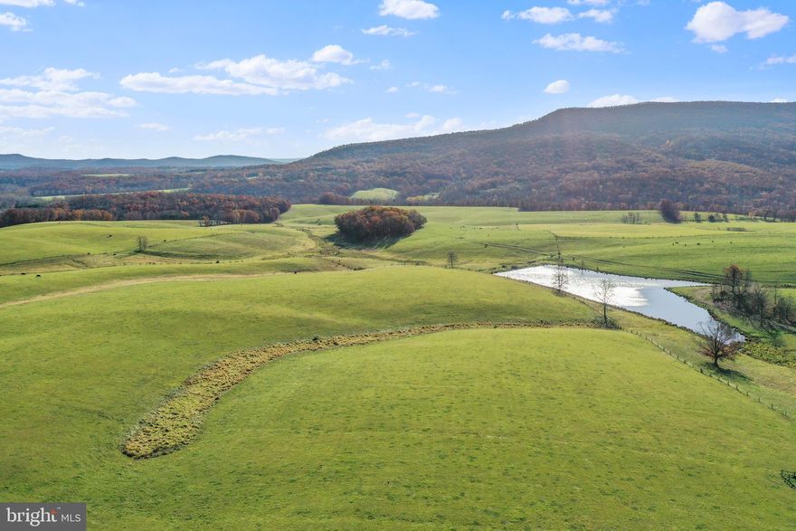 Dreams Can Come True - 490.25-Acre Farm in Augusta, WV – Unparalleled Location, Boundless Potential. Nestled in the scenic heart of Hampshire County near Augusta, West Virginia, this extraordinary 490.25-acre farm presents a rare opportunity to own a vast and versatile property. Located just three miles off U.S. Route 50, the farm offers exceptional accessibility—only 90 minutes from Dulles International Airport—making it ideal for agricultural pursuits, savvy investment, or a peaceful countryside retreat. The property showcases breathtaking rolling topography, blending approximately 430 acres of open meadows and pastureland with picturesque, wooded areas that add depth and natural beauty to the landscape. Historically supporting robust beef cow-calf operations, the farm is fully perimeter-fenced and cross-fenced, ready to accommodate a variety of livestock grazing opportunities. Three tranquil ponds enhance the property, offering both functional utility and scenic charm.
Electricity is readily available along Ford Hill Road, providing essential infrastructure for agricultural operations or servicing one of the future residential homesites. Additionally, the property holds the potential for public water access, further increasing its versatility for agricultural development or expanded use. A conservation easement ensures the farm's natural beauty and character are preserved for future generations, safeguarding this iconic property while maintaining its inherent charm. Despite the conservation easement, two reserved homesites—one on each side of Ford Hill Road—offer opportunities for future residences or additional improvements without compromising the property’s integrity or appeal. This farm is more than just land; it’s a gateway to endless possibilities. Whether you envision continuing its legacy as a working farm, creating a personal recreational haven, or securing a long-term, inflation-resistant investment, this property delivers unmatched potential in a stunning rural setting. Its size, location, and features make it increasingly rare in today’s market.
Opportunities like this are few and far between. Don’t miss your chance to own this remarkable slice of West Virginia’s countryside. Farms with these attributes are a vanishing treasure—act now to secure a legacy property that promises endless rewards.
