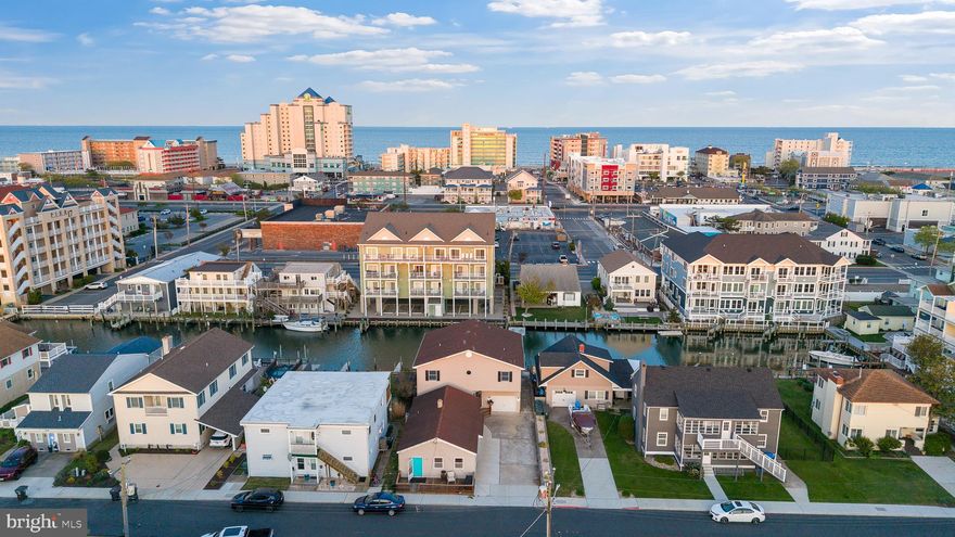 COME ENJOY THIS SPECTACULAR OPPORTUNITY.  VACATION WITH THE BEST OF THEM AT THIS INCREDIBLE ADDRESS.  JUST A SHORT WALK TO THE FAMOUS BOARDWALK AND BEACH BUT SET ASIDE IN A TRANQUIL NEIGHBORHOOD SETTING.  INCREDIBLE INVESTMENT OPPORTUNITY FOUND WITH THIS HOME-  ENJOY RENT FROM  A SEPARATE APARTMENT  WITH TWO BEDS AND ONE BATH MAKING FOR A PERFECT SUMMER RENTAL OR LONG TERM.  A  LARGE DRIVEWAY WITH MASSIVE GARAGE ALLOWS FOR AMPLE GUESTS AND COMFORT.  YOU'LL LOVE THE BOATING WITH PRIVATE DOCK & AND INCREDIBLE CANAL ACCESS TO THE BAY WITH A QUICK TRIP OUT TO THE OCEAN FOR WORLD CLASS FISHING.  LARGE 'MAIN HOME' OFFERS TWO BEDROOMS UPSTAIRS WITH TWO PRIVATE BATHS.  ENJOY MAIN LEVEL IN LAW SUITE WITH PRIVATE KITCHEN.  GREAT EXPOSURE TO WATER WITH MASSIVE REAR DECKS ON ALL FLOORS.  COME SEE A VACATION DELIGHT WITH AN INVESTMENT OPPORTUNITY ATTACHED TO IT TODAY!!