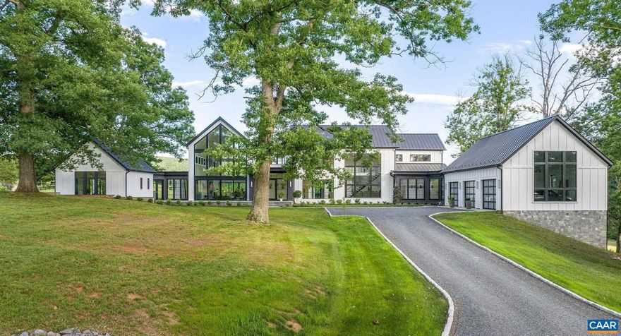 Sited beautifully amongst massive oak trees, this dazzling home enjoys incredible views of rolling hills & the mountains beyond, to the front and rear of the residence. The centerpiece of the interiors is a great room that soars to 31 feet with walls of glass to take in the views. Other ceilings are 10-11ft.  Dramatic stone & tile selections throughout. 1st floor master plus an additional 1st fl bedroom suite that doubles as a home office. 3 bedroom suites up and guest suite in the basement. A large, covered rear porch is ideal for entertaining next to the horizon pool. Features incl' wide plank oak flooring on all 3 floors, geothermal HVAC, home gym, and butler's pantry. Comprised of two 21 acre parcels, one of which fronts on Red Hill Rd, the property enjoys 2 entrances & can be subdivided. Below the house is a large, multi-purpose barn with half bath, devoted septic. Horse friendly land! Lovely, bold creek traverses the property. 15 gallon per minute well.  Fiber optic internet. 12 minutes to town, Boar's Head, Farmington et al,Marble Counter,Fireplace in Great Room