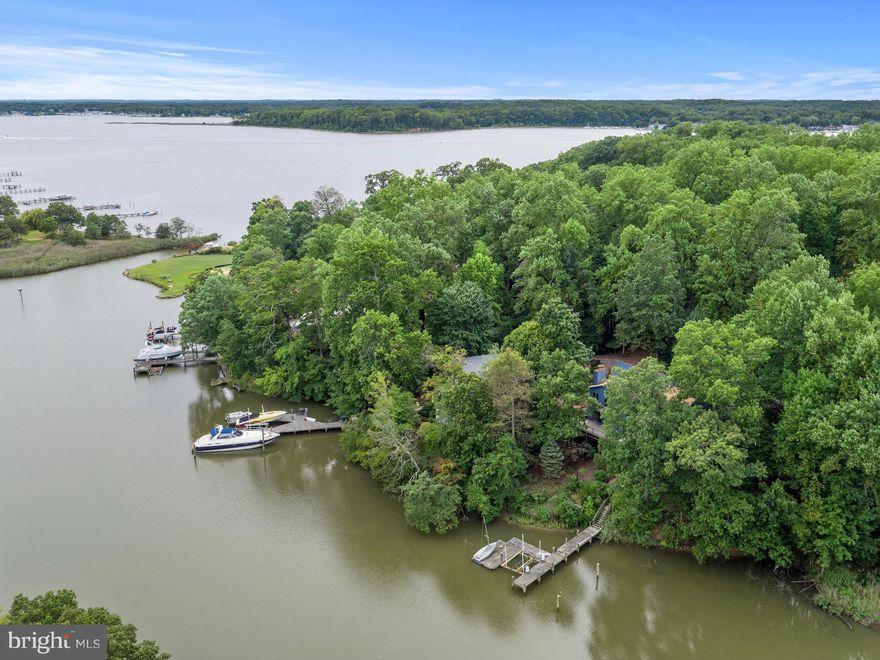 WATERFRONT - Spectacular views from nearly every room! 150' water frontage, pier w/boat lift, florida room w/hot tub & 50' deck to enjoy the view. Brand new SS appliances, granite counter, fresh paint, new carpet, cathedral ceilings, skylights, hardwood floors & the list goes on! Huge MBR w/fireplace, newly renovated spa bath & enormous walk-in closet w/ laundry. Private lot, it's perfect!