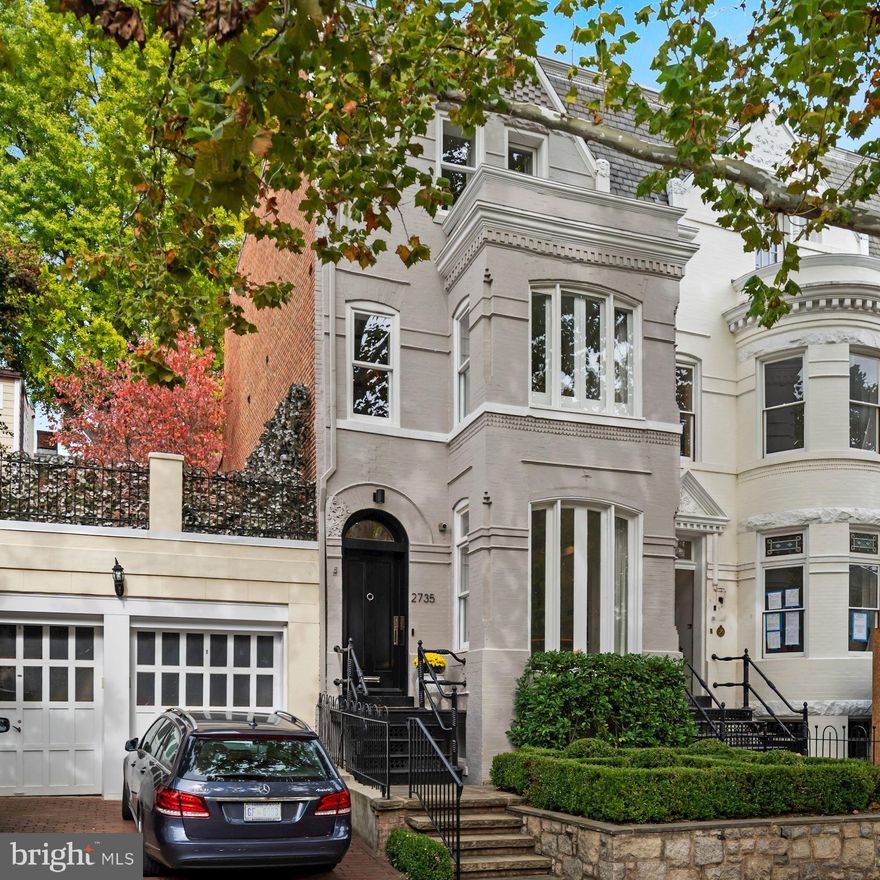 Refined living at its best in this modern masterpiece in Georgetown’s charming East Village. Top-to-bottom renovation by Akseizer Residential then finished by renowned designer Daryl Carter. This showpiece residence is sculpted to perfection with ADG’s signature architectural details and custom millwork throughout. Featuring a perfectly manicured front garden, herringbone patterned natural wood floors, 9-foot ceilings, gourmet kitchen with Quartz countertops, Thermador home-connectivity appliances, plus Waterworks bathrooms throughout. Artisan finishes abound, from the antique French marble fireplace in the living room to the private rear garden with built-in grill, expansive bluestone dining/lounge area, & manicured boxwoods. Savant premium home automation system controls climate, lighting, entertainment, & security from a single intuitive app. Upper Levels boast 9-foot ceilings with 4 Bedrooms and 3 Baths including the ultra-luxe Master Suite w/ double vanity, triple shower, dressing room with custom built-in wardrobes and more. The third level also features a convenient secondary Laundry, marble bar & private balcony overlooking Georgetown. Newly excavated Lower Level offers 9-ft ceilings, large family room, fourth full bath, marble bar with wine cooler and refrigerators, primary laundry room, as well as private front entrance from P Street. Includes secure single-car parking with automated gate in the rear garden plus additional rental parking.