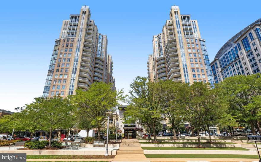 Experience unparalleled luxury living at Midtown at Reston Town Center, Reston's most sought-after address. This 3-bedroom, 2-bathroom condo with hardwood flooring boasts an open, modern design with sweeping floor-to-ceiling windows with automatic shades and soaring 9-foot ceilings that flood the space with natural light and showcase urban views. Perfect for entertaining, the open-concept living and dining areas lead to a balcony, ideal for relaxing or enjoying the scenery. The gourmet kitchen impresses with upgraded Aster Italia cabinetry, under-cabinet lighting, granite countertops, stainless steel appliances, a pantry, and a breakfast bar.  Newer kitchen GE appliances include a microwave in June 2023 and a refrigerator in April 2022. Thoughtful details like walk-in closets in the primary and second bedrooms, frameless glass shower doors, and a full-size washer and dryer with an automatic water detection and shut-off system add convenience and sophistication. HVAC was replaced in January 2022. This residence includes two deeded parking spaces (3035 & 3036) on the G3 parking level near the elevator and a storage unit (#126 – Storage Room 5) on the G2 parking level, enhancing your everyday ease. Residents enjoy unparalleled amenities, including a fitness center, library, private movie theater, conference room, party room with a catering kitchen, two outdoor patios with grilling stations, an outdoor swimming pool with a hot tub, and 2 guest suites for visitors. The on-site property management team and 24/7 concierge ensure comfort and peace of mind. Ideally located, you’ll find fine dining, premier shopping, a skating rink, a movie theater, live entertainment, and the W&OD trail just steps away, with easy access to the Reston Town Center Metrorail Station and Dulles International Airport. This Midtown condo offers a rare opportunity to experience refined living with unmatched amenities and thoughtful design, presenting a fresh canvas ready for your personalized touch. Come envision your new beginnings in the heart of Reston Town Center and make this space uniquely yours.