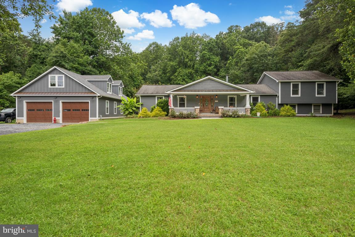Where to begin? This Craftsman-style gem truly has it all—space, location, and potential!
Nestled on nearly an acre in the sought-after Cheval Trails Community of Davidsonville, this home offers the rare combination of expansive indoor living, peaceful outdoor space, and exceptional versatility.
Step inside to discover a bright and airy open-concept layout anchored by a massive living room addition (built in 2001) that’s perfect for entertaining or simply relaxing. The space flows effortlessly, creating a warm and inviting atmosphere that feels both spacious and connected.
Enjoy the serenity of nature as the home backs to mature trees—providing a private and peaceful setting. Whether sipping coffee on the huge front porch or hosting a summer gathering on the back patio, you’ll love the seamless indoor-outdoor lifestyle.
But the showstopper?
A detached garage like no other—approximately 34' x 50', this oversized space easily fits at least 4 vehicles and offers high ceilings and ample workshop space, making it a dream for hobbyists, car enthusiasts, or collectors. Even better, the upper level holds the potential to be finished into nearly 1,000 sq ft of bonus living space—ideal for a future in-law suite, guest apartment, or home office.
Don’t miss this rare opportunity to own a home with character, convenience, and room to grow—inside and out!