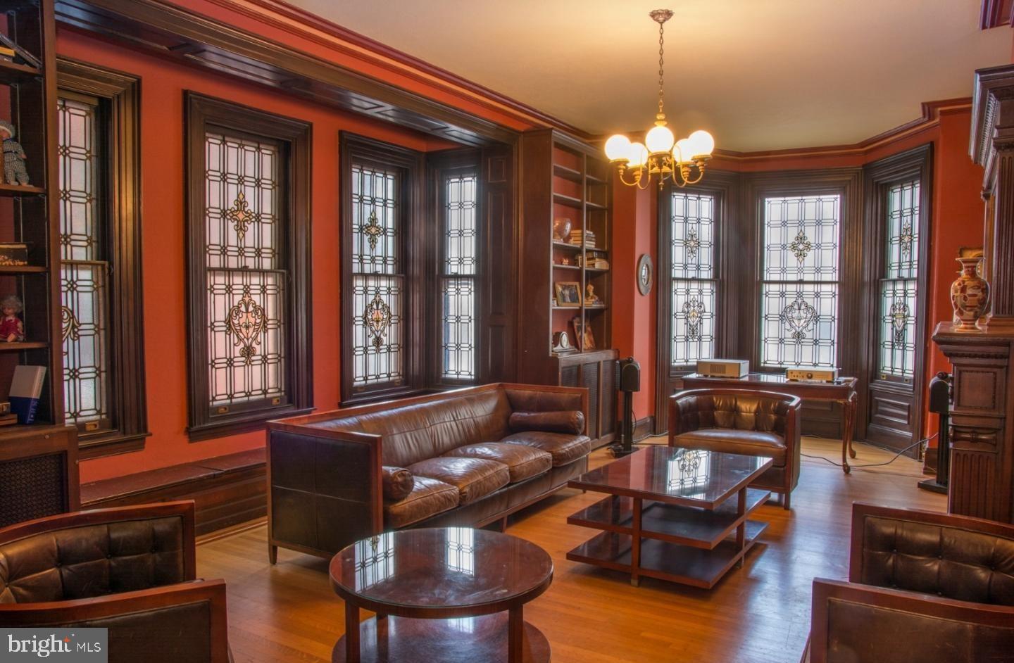 This is a historic townhome just off Rittenhouse Square that has retained most of its original features yet has been updated for modern living. It is one of the few properties on the block that has remained a private residence since it was built in the 1870 s. The historic elements of the property include 20 stunning stained & leaded glass windows, original interior window shutters, hardwood flooring throughout, three-story mahogany staircase & moldings, window seats, a skylight, fireplace mantles and other ornamental woodwork. The home has over 4,000 square feet on four full floors. The first floor has 13 ceilings, a wood paneled vestibule, and antique chandeliers and an entry hall with a large mahogany mirror. The grand living room has two entrances, large arched windows to the street, a marble fireplace mantle and ornately carved mahogany transoms. The elegant dining room has beautiful stained-glass windows, a large ornate fireplace mantle and wall sconces. The gourmet chef s kitchen has imported German cabinetry, granite countertops and high-end appliances from Miele, Subzero and Thermador. The second floor contains the master suite, which includes a large bedroom, dressing room with ample closet space and the master bath. The master bath has a large walk-in shower stall and sunken whirlpool tub. There is a large den or library on this floor that has stained glass windows, a dry bar and custom mahogany bookcases, mantle, window seats and moldings. The third floor has three large bedrooms, one bath and a kitchenette. The fourth floor has two bedrooms and a bathroom that could be used as an en suite bedroom and sitting room. The bedrooms offer beautiful skyline views. The lower level, which is still above ground, includes a family room, bathroom, laundry room and direct access to a beautifully landscaped patio. The property has a full basement with ample storage. This home is located on a beautiful block of the historic Rittenhouse Square neighborhood, which has some of the best restaurants, cafes and shops in the city. Fitler Square and Schuylkil River Park are also just a few blocks away. The area also has some of the highest rated schools in the city. There are many parking, gym and yoga options nearby.