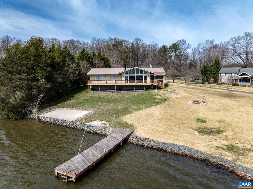 UNPARALLELED WATERFRONT OPPORTUNITY in Blue Ridge Shores! Experience the ultimate lakefront lifestyle on this rare, level 0.75-acre lot boasting 150 feet of private water frontage with its own dock and beach. This spacious, move-in ready ranch has been thoughtfully updated to blend comfort with incredible value. Step inside to a sun-drenched open floor plan featuring soaring vaulted ceilings, a cozy stone fireplace, and brand-new expansive windows designed to frame wide-open lake views. Recent 2025 Cosmetic Upgrades include fresh paint throughout, plush new carpet, and durable luxury vinyl plank flooring. Major mechanical peace of mind comes from a replaced HVAC (2022), a new water heater, and a roof/siding refresh (2018). The functional layout offers 3 bedrooms, 2.5 baths, and a dedicated home office, totaling over 2,300 finished square feet on one level. Enjoy summer nights on the screened porch, sunset dinners on the lakeside deck, or s'mores at the dedicated fire pit. Complete with an oversized 2-car garage and paved drive, this is the premier choice for a primary residence or a high-potential lake rental. Own the best lot on Lake Louisa! Enjoy community beaches, boat ramps, tennis, pickleball, and year-round events!,Formica Counter,Painted Cabinets,White Cabinets,Fireplace in Living Room