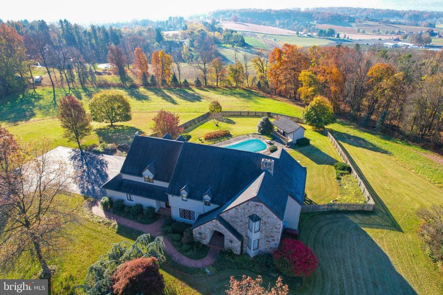 This home is located in a serene park-like setting in western Lehigh County, Pennsylvania. The property offers a stunning view of the South Mountain from the south-facing rolling hills and farmlands. The driveway is lined with trees and leads to a spacious parking area and a 3-car garage. The home features a deck and cabana porch that overlooks the professionally landscaped grounds, heated in-ground pool, and hot tub. The finished cabana has a powder room and provides guests with a private changing area. The den offers a picturesque view and is ideal for an in-home office. The sunroom is designed to take advantage of passive solar heating and allows abundant sunlight. The lower level recreation room has a kitchenette and powder room, providing additional space for entertaining. The home is adorned with high-end fixtures and appliances, cherry floors, solid wood doors, and a custom-crafted curved stairway, which sets it apart from other homes.
This home is a perfect blend of luxury and comfort, offering a peaceful retreat from the hustle and bustle of city life. It is an ideal place to relax and unwind, while enjoying the scenic beauty of the surrounding countryside.