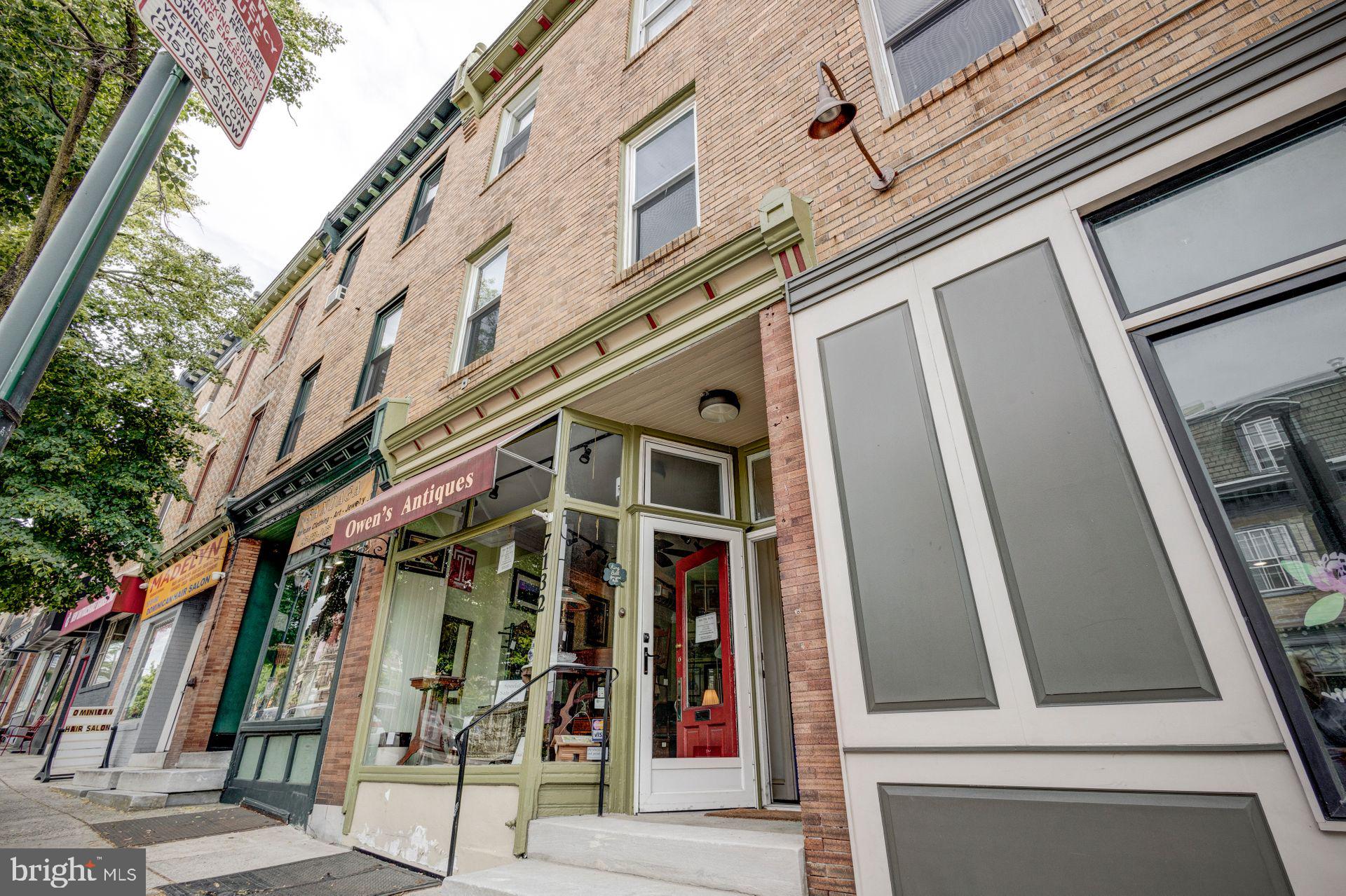 Welcome to this well-maintained mixed-use property located in the heart of the Central Mount Airy Commercial Historic District. This remarkable building is one of a row of ten three-story brick buildings, designed and constructed by architect Frederick Fox in 1898. This property offers a blend of historical charm and modern functionality with a prime location making it an ideal investment opportunity. The first floor features a large commercial space, perfect for a variety of business ventures. It includes a kitchen, a private back office, and access to a basement with ample storage space. The commercial space has forced air heat and air conditioning. The property's utility setup is highly efficient, with separate electric and gas utilities for each unit. The second and third floors house spacious 1-bedroom apartments, each with residential leases in place. These upper-level units are designed for comfortable living with features such as gas cooking, in-unit stackable washer/dryers, split systems for AC and ample natural light. Additional amenities include a large rear shed providing extra storage space and a rear yard area with convenient alley access. Located in the vibrant Mount Airy neighborhood, this property benefits from its proximity to an array of shops, restaurants, and transportation options, ensuring convenience and a high quality of life for both commercial and residential tenants. Don’t miss the opportunity to own a piece of Mount Airy's history while enjoying modern amenities and a prime location!