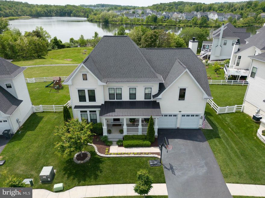 Welcome to this stunning home located in the highly desirable Lake Point Community in Round Hill. Boasting one of the largest lots in the community and over 4100 square feet of living area on three levels, this property offers ample space for family and friends to gather both inside and outside of the home. With 4 spacious bedrooms and 3 1/2 bathrooms, everyone is sure to have their own private space. You'll be impressed by the vaulted ceiling and cozy fireplace in the family room, while the custom built-in bookshelves in the office provide space for work or study. The kitchen has gorgeous white cabinets, a center island, and the best views of the lake.  The large master bedroom features huge closets with custom cabinetry, ensuring that storage space will never be an issue. Downstairs, the finished lower level includes a bar, great room, and gym space, making it the perfect spot for every family member.  This home draws you outside with a Trex deck that provides the perfect spot to relax and take in the stunning views of the lake.  Step down onto the beautiful paver patio with a built-in grill, perfect for al fresco dining.  In the colder months warm up in the hot tub.  Feeling adventurous?  Enjoy the lake life on a paddle board or non-motorized boat or do some fishing from the shoreline.  This is THE home in the neighborhood, so act fast because this one will go quickly.  Schedule a showing today. This one will go quickly.