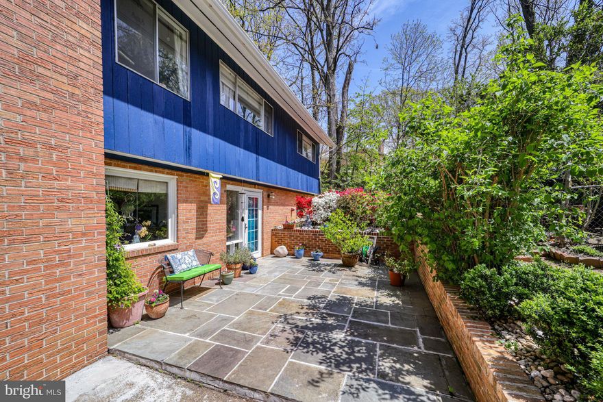 5 bedroom/2.5 bath in an updated contemporary home nestled in and surrounded by quiet gardens and mature trees. The home has a gorgeous designer kitchen with stainless steel appliances, upgraded cabinetry and lighting, under the counter water filter, and quartz countertops. The full baths have been updated and the newly renovated primary bath has a beautiful walk-in shower. 

The walk-in level has a large family room, a very versatile workroom/hobby space and an additional office space or bedroom, plus a 5th bedroom and half bath.  A great floor plan for an at home office or separate living space.
 
The home has been in the family for many years, lovingly cared for and updated with fresh color, a new roof (with transferable warranty), well maintained hvac system, and a completely new water line. Large and plentiful closets, along with a full-floored attic provide exceptional storage.
 
The natural light shining through the large picture windows in the living room creates a tree house effect, as it is on the upper level of the home looking out to the mature magnolia tree. Or sit on the spacious raised deck just outside the living room and become one with that gorgeous view! In the dining area is a beautiful paned sliding door out to the private patio and other hidden gem sitting areas! Take your time and walk the property as well as the interior of this fabulous home – every turn will delight you! A quality home in a wonderful location close to the Metro, Old Town, Ft. Belvoir and the beltway!
 
This property is designated as a Certified Wildlife Habitat, called Sanctuary Bliss, and for good reason! The organic landscaping, through great thought and care, regularly welcomes deer to saunter by! The exterior of this home extends the living space and blends with its natural surroundings. Here is your refuge! Floor plan is in documents section along with upgrades.