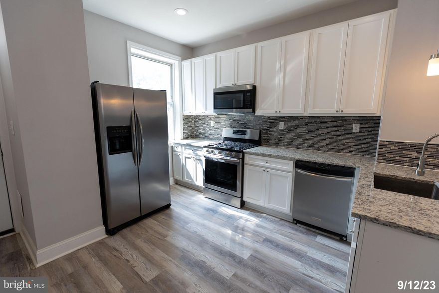 Buyer's got cold feet! Come take another look at this beautiful property. Seller is motivated! This spectacular end-unit townhome was completely gutted and renovated in 2021.  Conveniently located minutes from I-83 and all that Baltimore has to offer! This home features an open floor plan, a neutral color palette and an exposed brick wall.  The lovely living room hosts brand new engineered wood flooring.  The inviting dining area is perfect for entertaining.  A gorgeous eat-in kitchen boasts a breakfast bar, granite counters, stainless appliances, ample bright white, soft-close cabinets and gas cooking.  There is a conveniently located main level powder room.  On the upper level are three generously sized and sunny bedrooms with new plush carpet and a full bath.  The unfinished basement offers endless storage.  On the rear is a covered porch, a yard or parking pad.