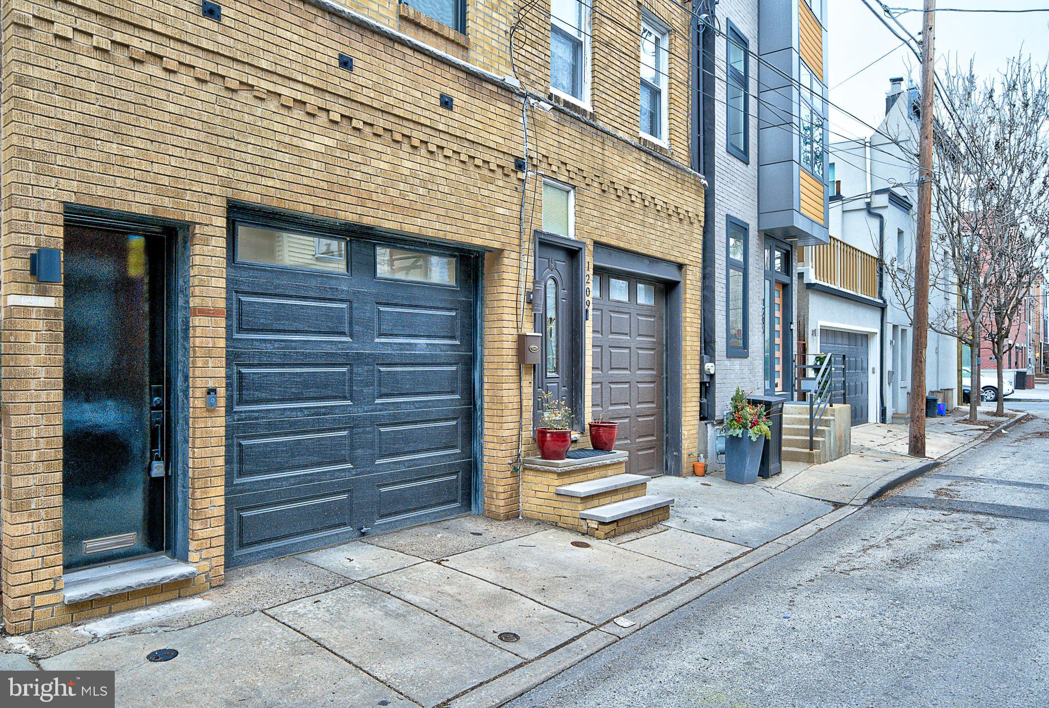 Opportunity is here! This beautiful, loft-style three bedroom, two bathroom PLUS GARAGE townhouse embraces and reflects the industrial roots of Annin Street while bringing the necessary comforts of luxury living to its residents. This home is just a moments’ walk away from the shops and restaurants of Passyunk Square AND of the Italian Market.
From the enormous, newly refinished fiberglass rooftop, you and your guests can use the pilot house wetbar to pour cocktails while viewing the city skyline, grilling, and relaxing by the fireplace. Park your car directly under the home in the attached garage – there’s no need to search endlessly for street parking! Don’t drive often? The house is only two blocks from the Broad Street Subway, making access to Center City and the Stadiums a breeze.
Looking for a quiet place within the bustling city? This home features a wonderful dead-end street where traffic and street noise are at a minimum and children often play. The unique third floor living space further enhances the privacy and quiet nature of the home as street noise very rarely interrupts your dinner conversation or a night of binging Netflix. Additionally, the extra-long windows in the living room and custom picture window in the kitchen offer plenty of natural light.
The bedrooms feature significant closet space with numerous built-ins so that you are never in need of storage! Both full bathrooms are beautifully finished with stone floors in the showers and tile backsplashes. Need an ensuite for guests? The downstairs bedroom features a full closet and full bathroom of its own for the privacy and separation a guest might need.
As for the rest of the house, the pictures speak for themselves. This home features beautiful solid oak hardwood floors throughout, 42” cabinetry, high ceilings, stainless steel appliances, granite countertops, front load washer and dryer, completely new HVAC system (2022), recessed lighting and ceiling fans in every room. This house is completely move-in ready. The only thing missing is you!