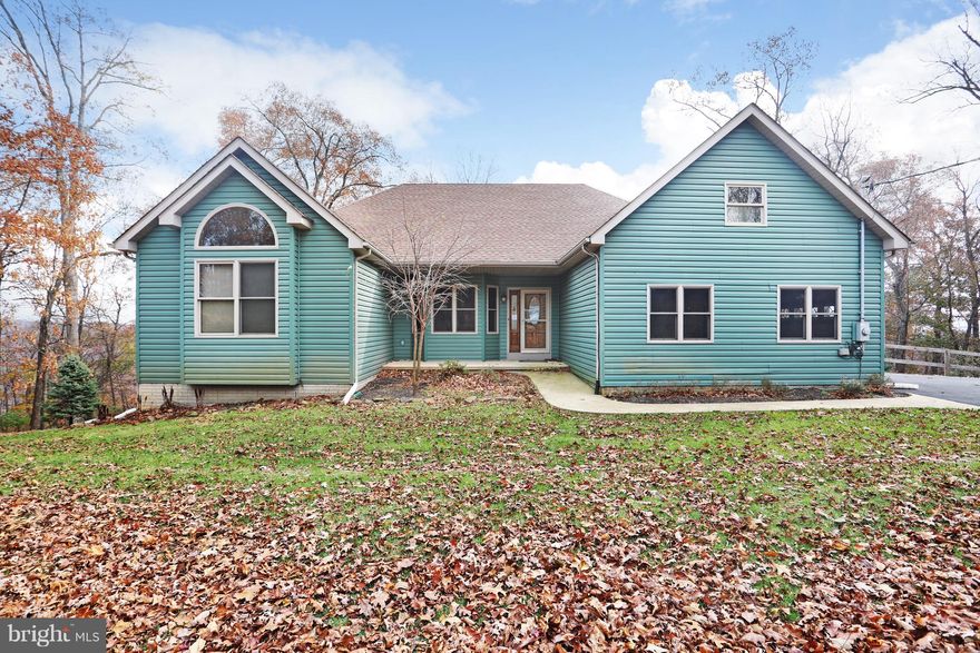 CUSTOM BUILT Rancher.  One level living with guest living down with walk out finished basement.  Entertain in Great room with fireplace. Huge family room with bar and pellet stove and access to patio.  Private Community beach and fishing. Public golf course just down the road. Enjoy the changing seasons on your huge rear deck with top of the word views. Fenced yard with fruit trees. Fire pit for enjoying cooler nights. Huge entertaining area with 2 bedrooms and full bath down. Office, master bedroom with large master bath, separate commode room and wonderful soaking tub. French doors lead to great deck which runs the length of the rear of home.  Well built with 2 X 6 walls. Seller paid Home Warranty included. Located in Morgan County but close to Berkley County Line.