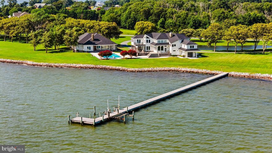 Most waterfront properties give you a view. This one gives you an entire Peninsula.
Set on 6.39 private acres in the prestigious South Point Farms community, this extraordinary waterfront estate offers more than 700 feet of direct bayfront and a setting that feels worlds away from everything, yet  minutes from the best of the Eastern Shore.
Properties like this are not simply waterfront. They are surrounded by it.
From its rare peninsula-style position, the estate captures sweeping, unobstructed water views in nearly every direction. Sunrises over the bay. Evening light reflecting across open water. Quiet mornings where the only sound is the tide moving along the shoreline.
The custom built property was designed to blur the line between indoor comfort and outdoor living. Anchoring the estate is a 4,165 square foot main residence, thoughtfully positioned to take full advantage of the panoramic waterviews and endless skyline.
Inside, nearly every room faces the bay. Soaring ceilings frame a grand great room with a traditional fireplace, while the chef’s kitchen, dining area, and sitting spaces flow naturally toward the surrounding decks and water views. The main-home offers four bedrooms, four and a half baths, two dedicated home offices, and multiple gathering spaces designed for both everyday living and large waterfront entertaining.

Step outside and the experience continues. IPE Brazilian hardwood decks stretch along the waterfront side of the home, creating an ideal setting for sunset dinners, crab feasts, and long summer evenings overlooking the bay. A thoughtfully placed bay-facing 'bonus' garage provides convenient storage for boating gear, waterfront equipment or a perfect place for a home gym.

Just steps away from the main-house is the 1,619 square foot guest-home, creating a private retreat for visiting family and friends. Two bedrooms, a full bath with sauna, a vaulted wood ceiling family room with fireplace, and a professional-grade kitchen allow guests to settle in comfortably for extended stays. 
The guest house overlooks the estate’s 50' x 24' bay-facing in-ground pool, where wide water views become the perfect backdrop for both relaxing and entertaining.  A fully conditioned oversized-garage and game room adds another layer of entertainment space and is attached to the back of the guest house.
For boaters, the waterfront infrastructure is equally impressive.  A 250 foot private pier extends into the bay, providing quick access to open water, with more than enough room for your boat and your wave-runners. More than 700 feet of newly installed rip-rap shoreline protects the property while preserving its natural beauty.
The grounds themselves are as memorable as the waterfront. Professionally landscaped acreage surrounds the home, highlighted by a half-acre deep-water pond, expansive lawn areas, and a circular drive that creates a grand yet welcoming arrival.
And while the estate feels remarkably private, the location keeps you connected to the region’s most celebrated destinations.
Assateague Island National Seashore is just minutes away, offering protected beaches, wild ponies, and miles of untouched coastline. The shops, restaurants, and charm of Historic Downtown Berlin, consistently ranked among America’s best small towns, are nearby. And when you want the energy of the coast, the beaches, boardwalk, and marinas of Ocean City are only a short drive away.
Waterfront estates of this scale, privacy, and peninsula positioning rarely become available in Worcester County, or anywhere on Marylands Eastern Shore.  Especially not with this combination of acreage, infrastructure, and proximity to the coast.
For those who understand what a property like this represents, it is more than a home.
It is a legacy waterfront setting that simply cannot be recreated.