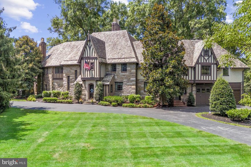 Welcome to 1006 Westover Road, the very first house built in all of Westover Hills. Nestled on a prominent 1.4 acre corner lot, this 1927 Tudor style masterpiece, designed by William Woodburn Potter, boasts an impressive amount of timeless elegance. This  quintessential Westover Hills home boasts 5 bedroom, 5 full bathrooms, 2 powder rooms, formal living and dining rooms and grand architectural details. The Foxcroft stone laid exterior and slate roof exude a stately charm, while the property's location in this prestigious neighborhood ensures both privacy and exclusivity. Step down into the elegant formal living room that boasts a stunning French Caen stone fireplace clad with wood paneling and oak beamed ceiling. French doors open to the lovely enclosed porch leading to the flagstone terrace. Beveled glass doors lead to the family room which features a barrel ceiling, built in shelving, and a cozy stone fireplace with wood mantel. The family room also provides access to the terrace. Host dinners in the well appointed formal dining room boasting a crystal chandelier, sconces and crown molding. French doors lead from the dining room onto the solarium. Off the foyer you will find the original telephone room which can be utilized as an office. The gourmet eat in kitchen is a chef's dream. The center island seats four and has a granite countertop and sink. The well appointed kitchen features high end appliances including a Dacor 6 burner gas range with double oven and both a Sub-Zero refrigerator and separate Sub-Zero freezer. Adjacent to the kitchen you will find a very spacious butler's pantry. The dramatic carved limestone staircase is adorned with a hand-hammered wrought iron railing. The sunlit stairway is lined with the original lead glass windows. The master suite is a elegant retreat with 2 full bathrooms with Carrera marble vanities and a spacious dressing room. Charming features include a French doors to a Juliet balcony, large bay window and mill work.  The second bedroom connects to the second primary en suite. Currently used as an office, this room features a built in desk creating a functional work from home space. The third bedroom has a brick fireplace, walk in closet and an en suite bathroom with a Carrera marble vanity. The fourth bedroom also has an en suite bathroom and cedar closet. Down the hall is the sixth bedroom and full hall bathroom. Expand your living space in the versatile recreational room at the end of the hall. This estate seamlessly blends historic charm with modern amenities, making it a truly unique and inviting place to call home. Throughout the home you will find vintage architectural details such as hardwood floors, original faience tile, stunning ceilings and elegant fireplaces. The home is situated on a beautiful large corner lot and features manicured lawns, extensive hardscaping and an inviting flagstone terrace. They simply do not build homes of this caliber anymore. We invite you to come discover the unmatched sophistication of this wonderful home.