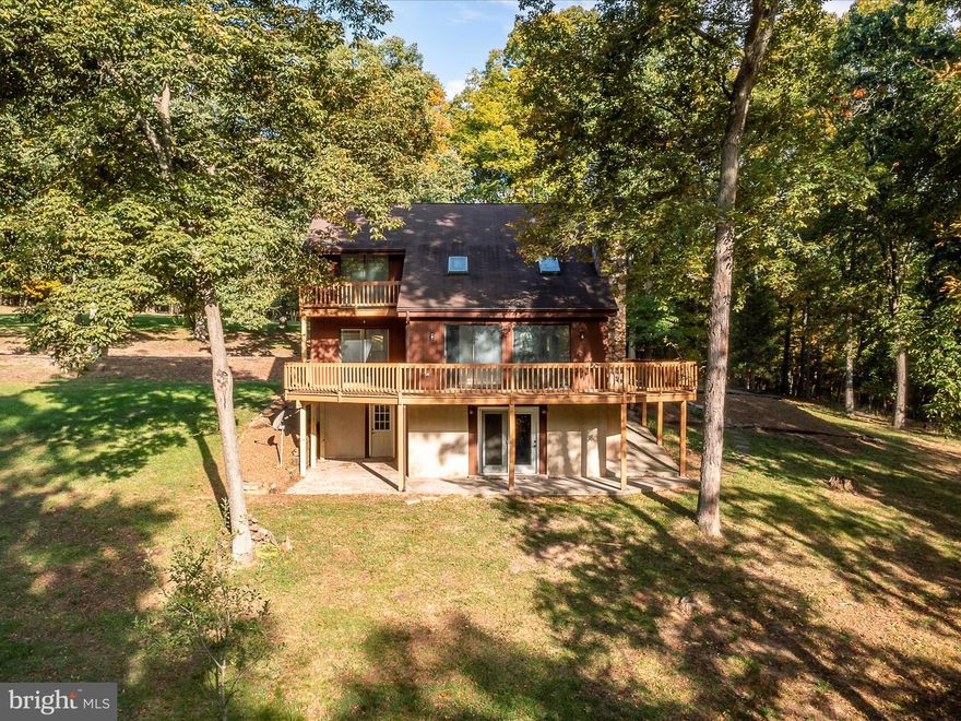 MULTIPLE OFFERS IN HAND. Highest and best due by tonight, Sunday the 15th at 9PM. Move In Ready 4 Bedroom, 2 Bathroom Chalet, with approximately 2,339 square feet, nestled on 5.39 acres. This home has recently undergone some major improvements, with new hardwood flooring, new carpet, new LVP, fresh paint from top to bottom, new hardware and fixtures. The kitchen is upgraded with new cabinets, new granite counter tops, and new stainless-steel appliances. Other features include a refinished wrap around deck, upgraded plumbing, new vanities, all new interior doors, new gutters, a wood stove and a patio. One of the upstairs bedrooms has access to a walkout deck. This 5.39 acre lot features privacy and many mature trees. Schedule your sowing today.