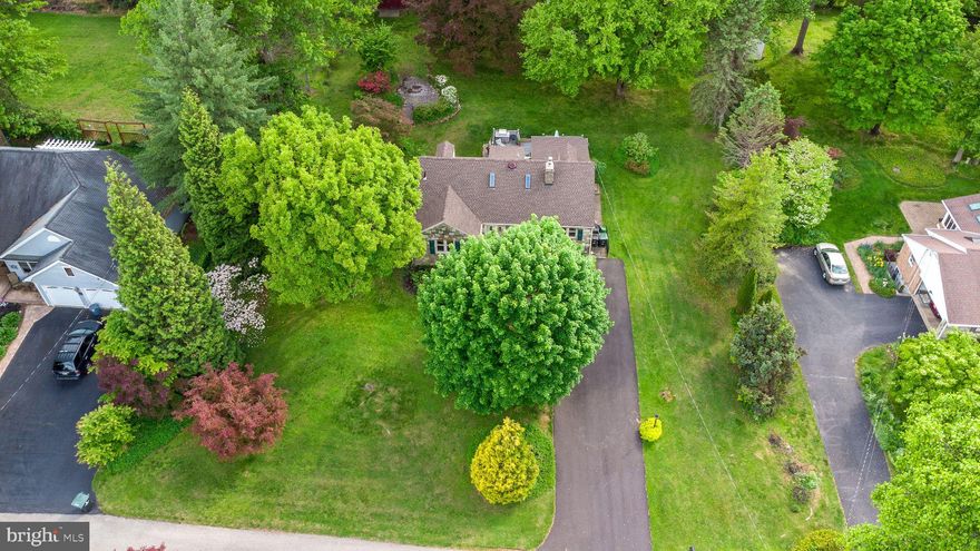 *Showings begin 5/15, Open house 5/17 * Classical and charming, stone beauty!  Be impressed when you step through the threshold of this home with many period and quality features from the mid 20th century including: a stone fireplace, recessed wall alcoves, cast iron radiators, archways, hardwood floors and more.  Balancing traditional features with modern amenities, the updated kitchen features brand new granite countertops,  with sleek black and stainless appliances. Just off the kitchen is a massive, light-filled dining room with chair rail, and crown molding.  The cozy and character filled living room features a large bay window, recessed lighting,  fireplace, and multiple alcoves.  A den with vaulted, tongue and groove ceiling overlooks the verdant back yard.  Two bedrooms, and an updated full bath round out the first floor. The second floor has 2 additional bedroom, a full bath, and a loft/library area that  is currently used for crafts but could also be used as a library, play room, gaming room, music room. The possibilities are endless for this space. Transition easily to the outdoor space via the large deck which overlooks the huge and lush back yard. The yard is a gardener's delight dotted with beautiful perennials, and shade trees, and features a fire pit and patio. This classical beauty is conveniently located just steps to major commuter routes, shopping, dining, and parks and recreational facilities.  The flexible layout offers both first and second floor bedroom and bathroom spaces which can meet a multitude of needs. New roof installed in 2025. One year home warranty included