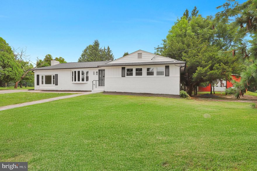 Discover this stunningly updated all-brick ranch-style home nestled on a peaceful 3-acre lot in the highly coveted Clarksville community. Set amid scenic rolling hills and surrounded by upscale properties, this distinctive home seamlessly combines classic appeal with contemporary finishes.

A circular gravel drive welcomes you to the bright and airy main level, where an open layout connects the spacious living area, dining space, and modernized kitchen. Just off the kitchen, a cozy family room with a gas fireplace opens to a generous deck and patio—perfect for seamless indoor-outdoor living and entertaining.

Three well-appointed bedrooms and two full bathrooms are located on the main level, including a serene primary suite with a beautifully renovated private bath.

The fully finished walkout lower level provides versatile additional living space, featuring a large recreation room with a wet bar, a fourth bedroom, another full bath, laundry area, and a dedicated storage or utility room—ideal for guests, remote work, or creative endeavors.

A true highlight of this property is the oversized detached structure that can serve as a barn, garage, workshop, or art studio—offering limitless potential for both hobbyists and professionals. The expansive outdoor space invites entertaining, gardening, or simply soaking in the quiet beauty of the landscape.

Tucked away on a quiet country lane yet conveniently located near shopping, major roadways, and some of the region’s best schools, this exceptional home offers a rare blend of privacy, charm, and everyday convenience. Don’t miss your chance to make this special property your own.

Mortgage savings may be available for buyers of this listing.