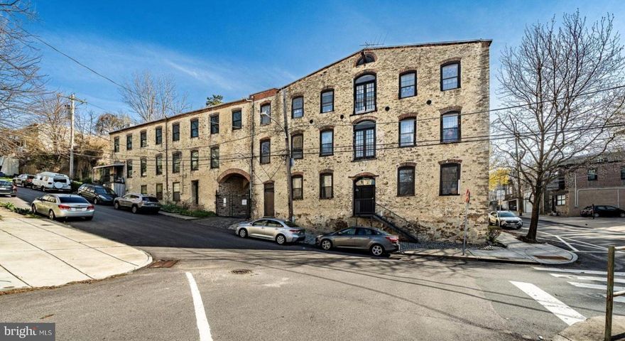 Why rent when you can OWN this beautifully updated one-floor condominium offering effortless living in Roxborough.   Set within a character-rich converted factory, this unique home blends historic charm with modern updates including high ceilings with track lighting,  exposed duct work and beams and rustic, hard-wood ceilings.

This bright and airy residence features an open floor plan designed for both comfort and entertaining, with an abundance of windows that fill the space with natural sunlight throughout the day a generous-sized walk-in closet.  The industrial roots of the building add a distinctive touch, complementing the clean, contemporary finishes.

Property taxes reflected are WITHOUT the homestead exemption.
Recent upgrades include brand-new flooring, a fully updated bathroom, and a modern kitchen complete with new cabinetry, new appliances and a quartz countertop, creating a fresh and move-in-ready feel. The seamless layout enhances the sense of space while maintaining a warm and inviting atmosphere.

Enjoy the added peace of mind of a built-in sprinkler system, along with the convenience of secure and private and HEATED garage parking with opener and outside entrance with key code in a highly walkable location and just minutes to Main Street in the heart of Manayunk, where you’ll find popular dining, shopping, and local attractions.
Perfect for those seeking low-maintenance living without sacrificing style, character, or location, this home is a true Roxborough gem.
