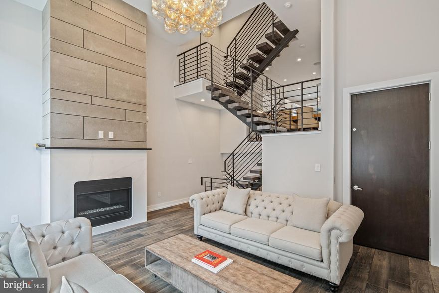 Presenting 1333 Bainbridge St, a stunning 5 bed, 3.5 bath home located in the private gated Kater Court community. Highlights of this 2 year old, like-new home include five private outdoor spaces- two roof decks & three balconies, 2-Car garage parking, a 7-stop elevator, over 4,200 square feet of living space, and 8.5 years of Tax Abatement remaining. Enter into the main sitting room featuring wide-plank hardwood floors that continue throughout the home and a stunning fireplace spanning from the floor to the 16' ceilings. Continue up to the open concept kitchen and dining room where you'll find top of the line Sub Zero and Wolf appliances, custom European cabinets, an oversized waterfall island, under cabinet lighting, and access to the first of five outdoor spaces. Up the floating stairs with 3-inch oak treads you'll find two spacious bedrooms each with walk-in closets and one with a private balcony. A tasteful hall bath with dual vanities and convenient upper-floor laundry complete the second level. The third floor Owner's Suite boasts a tranquil master bath, private Juliet balcony, and a fourth bedroom that has been converted into an enormous walk-in Wardrobe closet. An additional full bath on this level is convenient to the roof decks and fourth floor living space. This flex space offers the perfect place for entertaining, a home office, or sun-filled yoga studio. Take the elevator back down to the lower level where you'll find a fully finished basement with 12' ceilings, a second fireplace, and a separate den. Additional features of this incredible home include 8.5 foot solid core doors throughout, surround sound built-in on all levels, dual-zone Nest thermostats, and a Ring doorbell. Right in the heart of Center City, this property is located steps from South Street and within walking distance of Rittenhouse Square, Queen Village, and all of your favorite hot spots in the city. Make an appointment today because this home is sure to wow you!