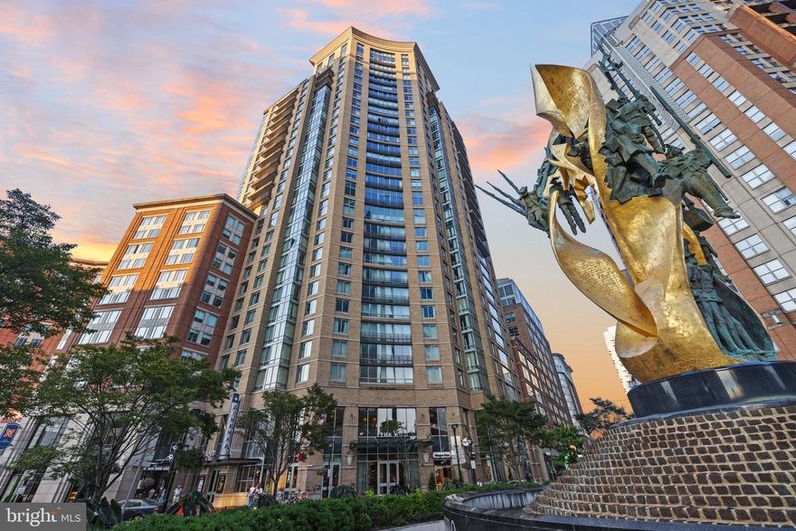Experience elevated city living in this spectacular corner two-bedroom, two-bath residence at The Vue, ideally positioned in the heart of Harbor East with sweeping water and skyline views. Framed by oversized windows, this exceptional home captures breathtaking vistas of the Inner Harbor, Patapsco River, and cityscape, creating a stunning backdrop from sunrise to sunset. Designed with both sophistication and comfort in mind, the residence features a newly renovated gourmet kitchen with sleek custom finishes, an expansive island perfect for entertaining, and seamless flow into the open-concept living and dining spaces. Every detail has been thoughtfully curated, including designer lighting, upgraded flooring, and striking custom wallpaper, all contributing to its triple mint condition. The spacious living area extends effortlessly to an expansive private balcony, offering the perfect setting for morning coffee, evening cocktails, or simply taking in the vibrant waterfront energy below. Motorized blinds and custom drapery add both convenience and elegance throughout the home. The luxurious primary suite is a true retreat, featuring dramatic corner windows, a walk-in closet, and a spa-inspired bath complete with a soaking tub and glass-enclosed shower. A generous second bedroom and full bath provide flexibility for guests, a home office, or additional living needs. One covered parking space is included. Residents of The Vue enjoy unrivaled convenience in one of Baltimore’s most sought-after neighborhoods, just steps from the city’s finest dining, boutique shopping, Whole Foods, Starbucks, the waterfront promenade, nightlife, Harbor East Cinemas, and direct elevator access to the MAC gym. A rare opportunity to own a fully customized, move-in-ready luxury waterfront residence in one of Harbor East’s premier full-service buildings.