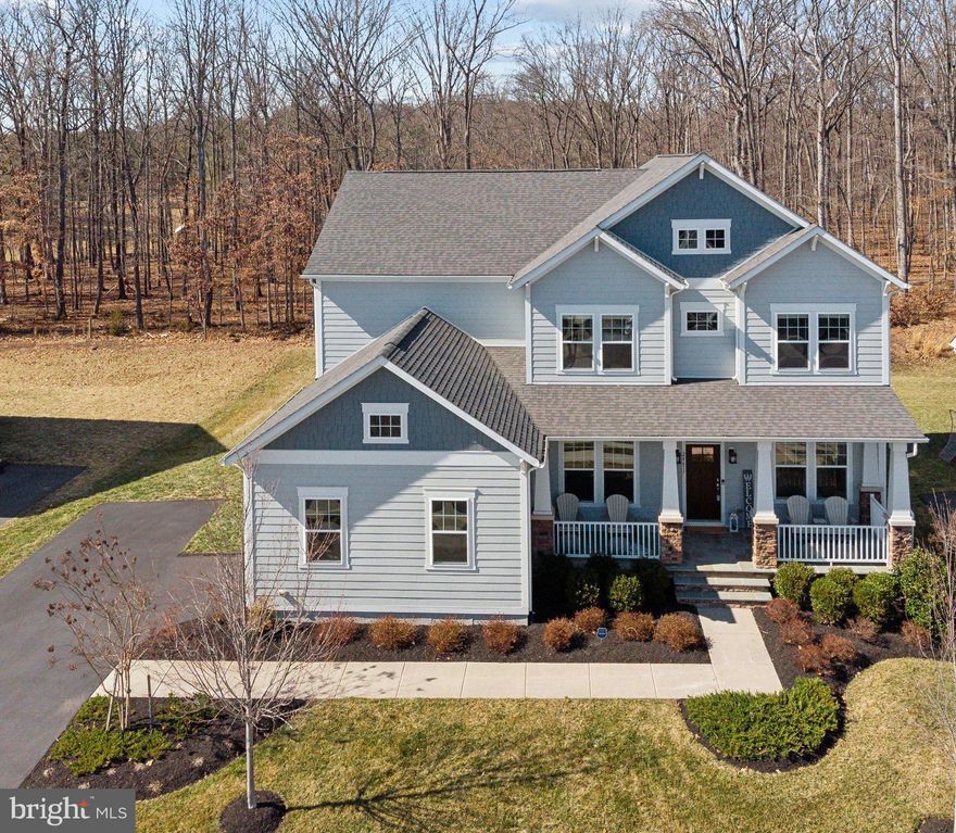 Willowsford Luxury Living Awaits in the Exquisite Ashford 2 Model

Experience the pinnacle of elegance in the sought-after Willowsford Grove, where this stunning Ashford 2 Model is nestled within an exclusive enclave of three cul-de-sacs. Offering unparalleled privacy with no through traffic, this home is set against a serene, picturesque backdrop of protected land that will never be developed.

Step inside to soaring 10-foot ceilings and an expansive open floor plan, thoughtfully designed for effortless living and entertaining. Curated by Beazer’s head interior designer, every finish reflects impeccable craftsmanship, with $230,000 in upgrades from the builder and $135k in post construction improvements. The gourmet kitchen features top-of-the-line finishes, an oversized island, and a seamless flow into the two-story family room, where coffered ceilings and a striking stone fireplace create a warm, inviting ambiance. A sun-drenched morning room extends the living space, opening to a spacious Trex deck, perfect for outdoor gatherings. The main level also features a private office with beautiful views, a formal dining and living room for elegant entertaining, and a versatile mudroom that can easily be transformed into a second office or spice kitchen.

Upstairs, the primary suite is a true retreat, offering complete privacy with no shared walls. Floor-to-ceiling windows capture breathtaking views of the conservatory nature trail, while the spa-like ensuite bath provides a serene escape. Three additional generously sized bedrooms, two full baths, and an upper-level laundry room complete the space.

The fully finished lower level is designed for ultimate entertainment, featuring a custom bar and kitchen, a professionally installed movie theater with built-in surround sound and a 134-inch screen, a gym, and a sauna. A private bedroom and full bath make this level ideal for guests or multigenerational living, while a large storage room ensures effortless organization for seasonal items.

Outdoors, the flat backyard is an idyllic oasis, perfect for play, relaxation, and al fresco entertaining. Step down from the Trex deck to a stone patio with a built-in fire pit and bench seating, all overlooking protected land that guarantees uninterrupted views and complete privacy.

Located just steps from Twin Ponds & Pavilion, this home provides easy access to scenic trails, a splash pad, and a dog park. As part of Willowsford’s award-winning community, enjoy resort-style amenities, including clubhouses, pools, a fitness center, zip lines, kids’ camps, social clubs, farm-to-table experiences, and year-round events.

This rare opportunity to own a one-of-a-kind home in Willowsford won’t last long. Schedule your private tour today!