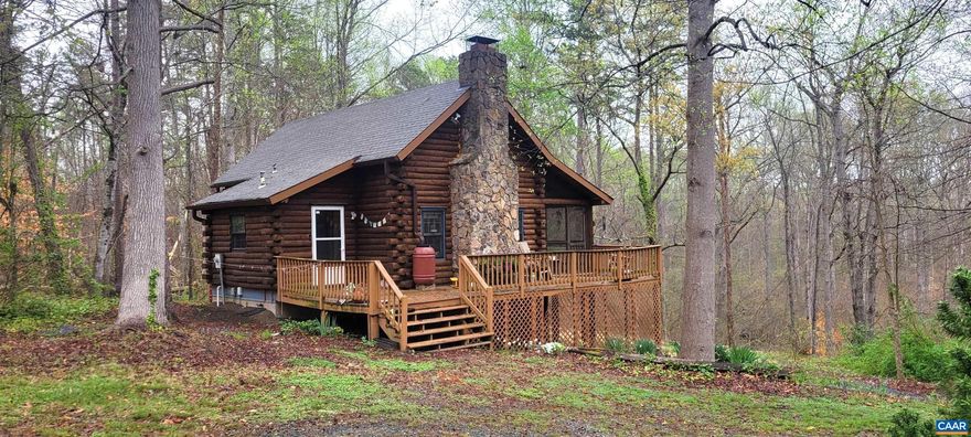 Charming Log Cabin on private & peaceful 5+ acre lot. Two story living area with stone fireplace, open kitchen dining area, large screen porch overlooking rear yard plentiful with trees and stream below. Spacious second story Loft/Primary Bedroom with view below to stone fireplace. Two bedrooms in the partially finished terrace level. Of course, wood floors throughout the main two levels. Additionally, a two car garage outdoor storage building and small greenhouse, plus plenty of room for a garden. Come and enjoy the tranquility of this home!