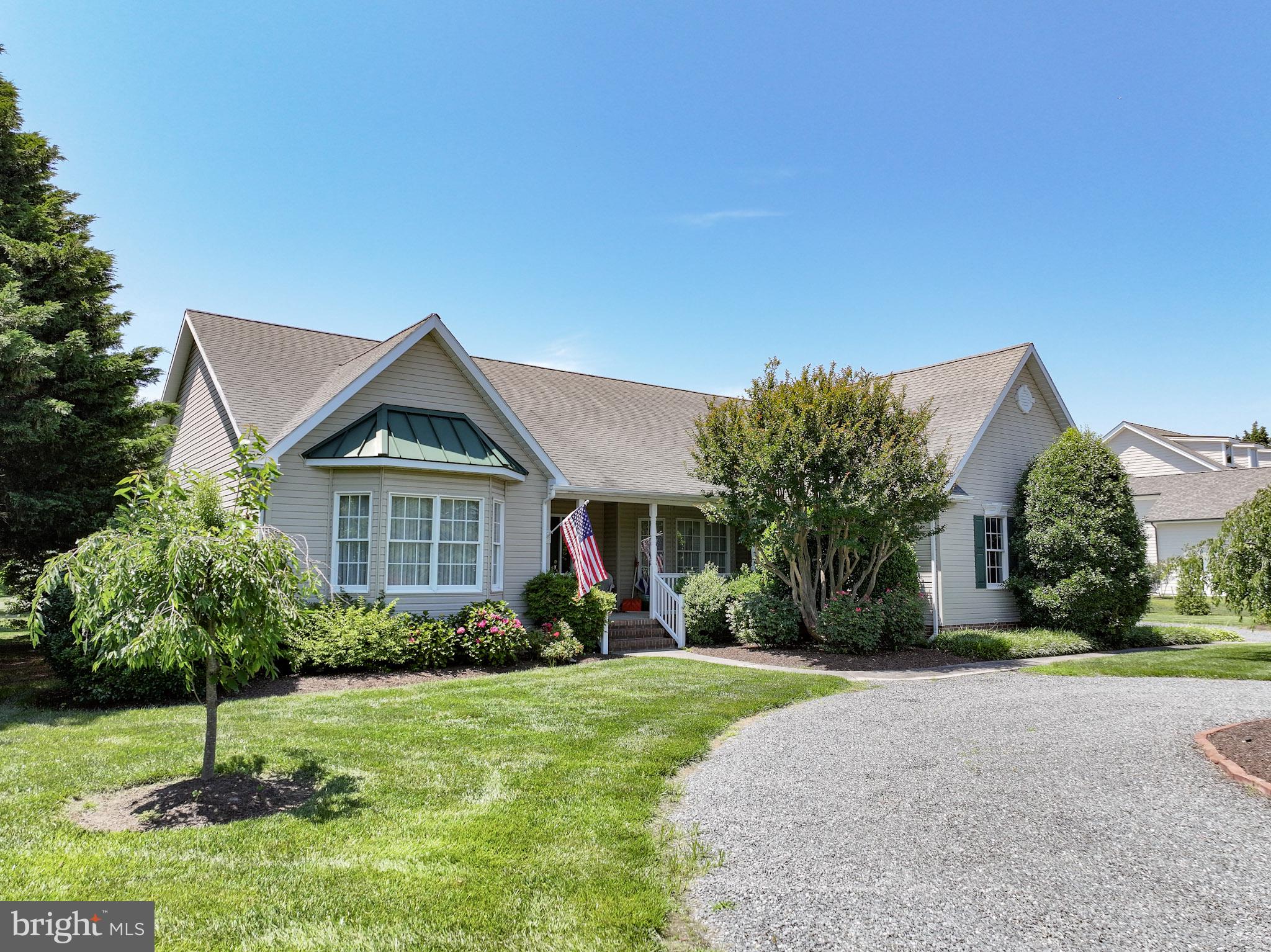 Located in the popular Martingham community just beyond historic St. Michaels, this well-built one-level home has a prime location, with The Links at Perry Cabin golf course right behind it. The open, spacious floor plan features a large primary suite at one end and two bedrooms and bath at the other for maximum privacy. The owners added a sunroom with a grilling deck off the side. The kitchen with newer stainless refrigerator and stove overlooks the great room with woodburning fireplace and hardwood floors.