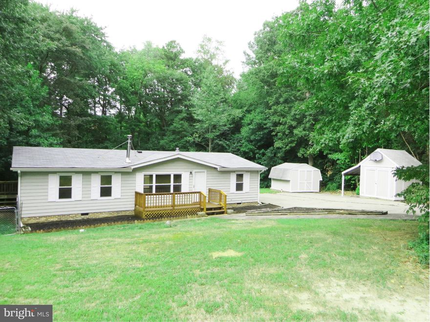 Great starter home on an acre, nice privacy & no HOA! You'll love the improvements: laminate floors; recent roof, gutters, & A/C; thermal tilt-in windows; light fixtures; vapor barrier & ductwork in crawl! Plenty of KT cabinets & counter space, w/pantry & gas stove. Warm woodstove w/new piping in LR, cozy in winter! Dining rm w/slider to deck. Sep laundry rm, W/D stay. Two sheds, huge paved drive!