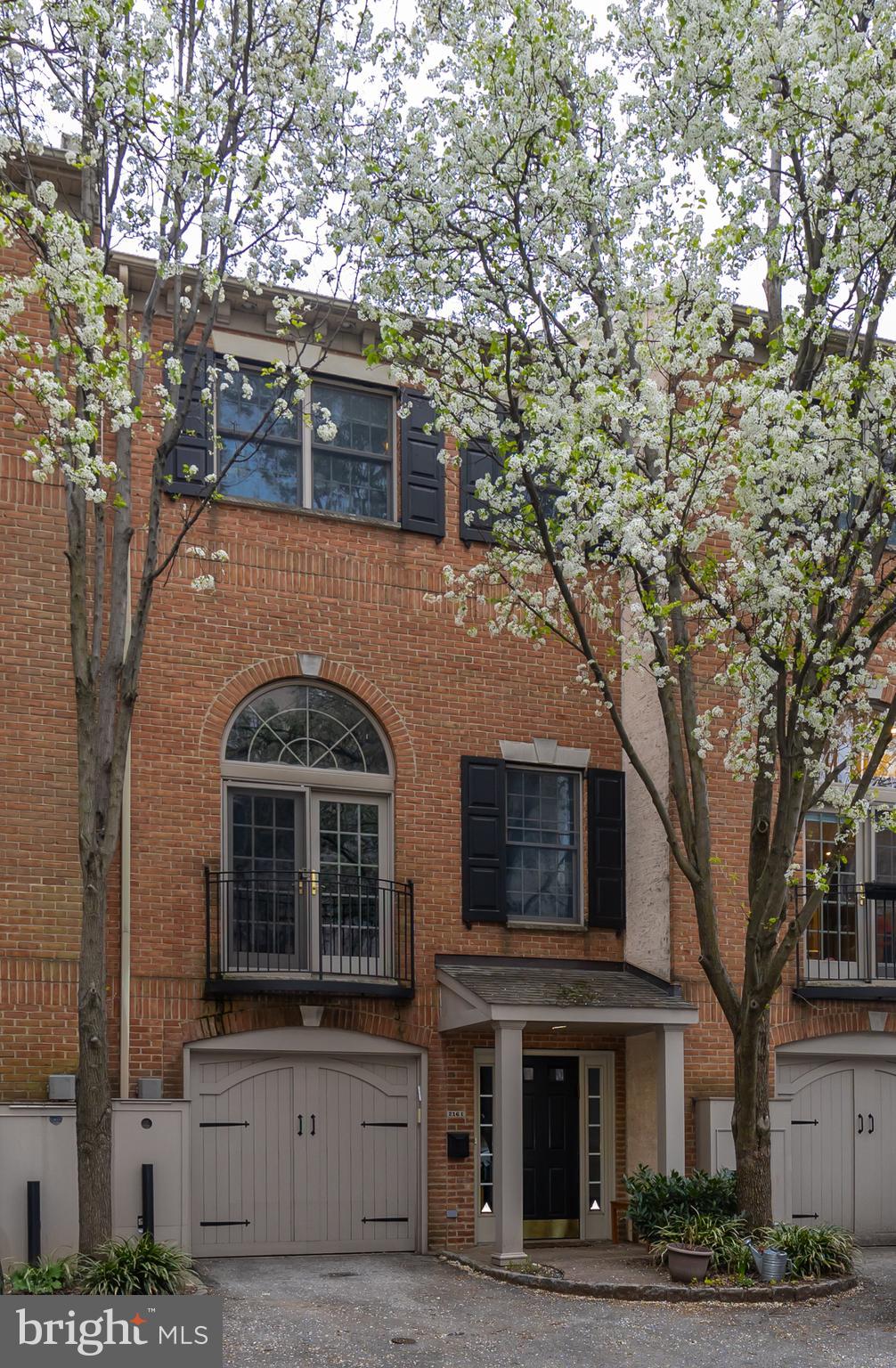 Welcome to 216 Christian Court E. This amazing home is the largest of 6 with a lovely courtyard entrance and TWO CAR PARKING in Queen Village. When you enter the wide entry hall you are immediately struck by the width of the home and the large spaces that spread more than 18 feet from wall to wall in each room. The spacious kitchen is updated with massive pantries, appliance nook, Wolf 6 burner stove, oversized farmhouse sink, and a brand-new premium Kitchen Aid refrigerator. Enjoy the large countertop or banquette table seating. Sunlight pours in the bay windows all day and a door leads to one of three outdoor areas where you can dine and grill outside.
A few steps below is a comfortable family room with a powder room and 2 impressive storage closets. The family room also leads to an outdoor patio that has access stairs to the kitchen from the outside. A few steps up from the kitchen you can walk into the double ceiling height Great room which is 400 square feet of impressive space highlighted by a gas fireplace and a Juliet balcony overlooking the front courtyard. Each of the three large bedrooms on the upper levels have walk in closets and en-suite bathrooms. There is also a full hall laundry room with basin sink. The primary suite has a raised ceiling, and a wall of custom wardrobe built-ins as well as a double closet passthrough to the primary bathroom.
A few more steps will lead you to the 325 square foot deck. The entire deck was just recently redone with a new TPO waterproof roofing material, new gutters with covers and composite raised paver decking. Plenty of space and skyline views!
So much to love about this home including wide hallways, endless closet space, spacious deck, fabulous kitchen, TWO CAR parking and storage area in garage but the Queen Village location is also ideal. Walk to Society Hill, the Italian Market, endless restaurants, coffee shops and playgrounds. Convenient to the waterfront paths which are undergoing massive upgrades. Convenient access to I-95, the bridges and the airport as well.