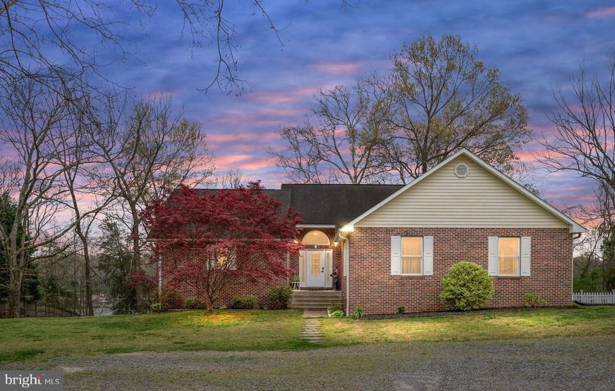 WATERFRONT Brick Home & Pier with Lift on Mattox Creek!   Come home to 2.35 acres of tranquility in a private setting.  This well-built home offers all the comforts of the waterfront lifestyle.  The Great Room's cathedral ceiling and impressive brick fireplace set the tone.   The adjoining Sunroom overlooks the water and connects to the dining area and waterfront deck, providing a gracious flow for entertaining. The large Owner's Suite has a wide water view, two walk-in closets, and a bath.  On another wing is the 2nd bedroom with bath, 3rd bedroom, hall bath, and laundry room.  The full basement is heated by a wood stove and has lots of potential with 2,374 sq ft.  The basement includes a finished bedroom/bonus room and bath, a family room, lots of storage, plus a generous workshop space.  The yard has a park-like setting and is level with a gentle slope to the waterfront.  The pier provides a safe harbor on the protected water of Mattox Creek with an electric hoist lift and water at the dock.  There's plenty of storage for vehicles, water toys, and more in the detached garage.  Located in the historic Northern Neck just minutes from the Town of Colonial Beach and about 90 minutes to DC or Richmond.  Furnishings are available and negotiable.  No HOA.  1-year American Home Shield Warranty included.