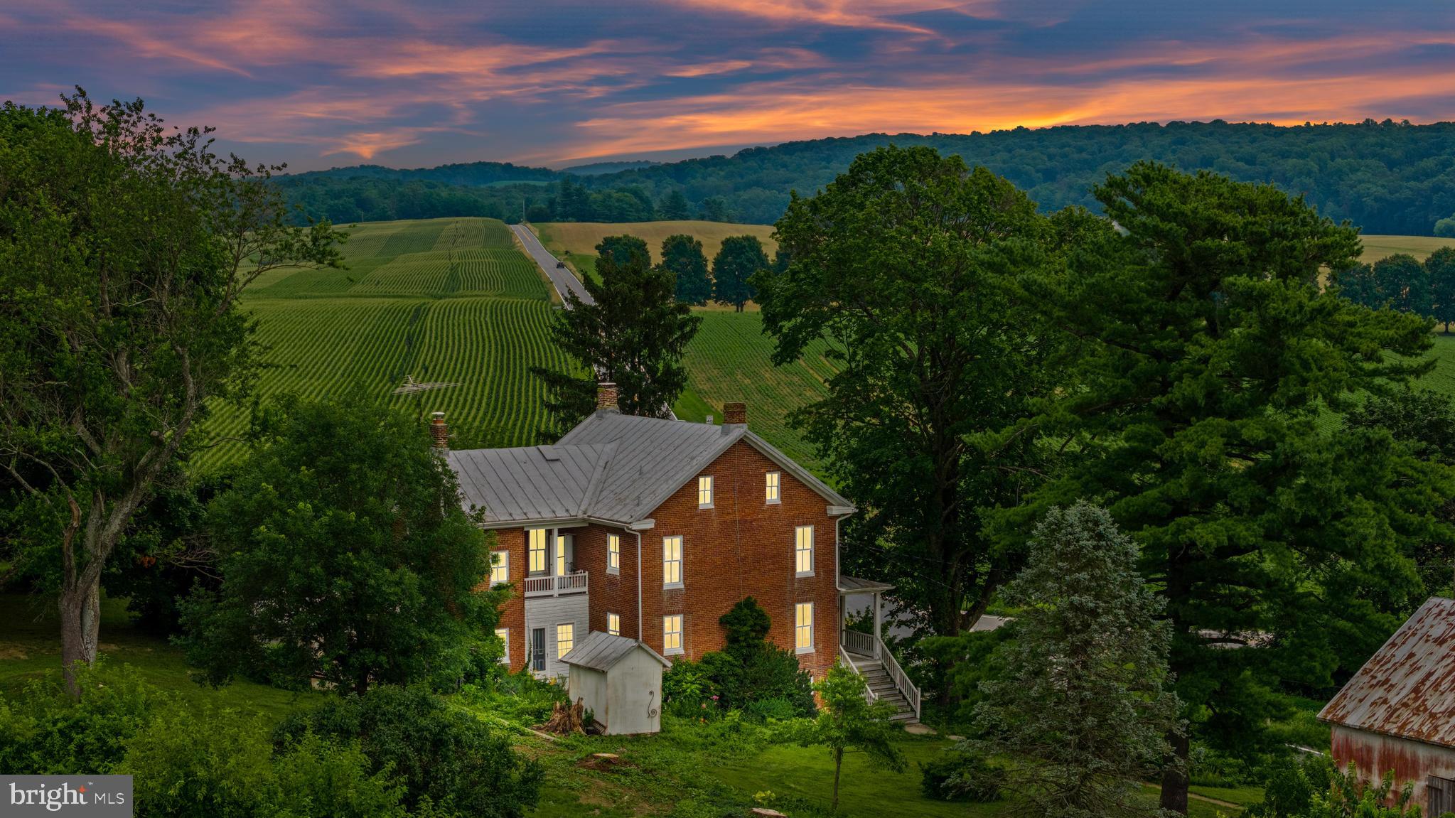 Discover timeless charm with this character‑filled farmhouse at 674 Old Bachmans Valley Rd, nestled on 4.45 picturesque acres in the rolling hills of Westminster, MD.
Built circa 1900, this residence blends historic heritage with modern comforts. Enter through the covered front porch, perfect for sipping that morning coffee and watching the cars roll by. Notice the classic attention to detail in this home from another time.
Hardwood floors have been maintained over the years and run throughout the home.
The lower level has a generous living room with a wood burning fireplace , a spacious country kitchen, back pantry/ laundry area, seperate main level bedroom with a full bath and a front parlor room. The stairs take up up to the second level complete with 3 additional bedrooms, a full bath and a covered porch off of one of the private bedrooms.
The attic has additional storage space or could be converted to a hand out space. The basement used to be the home to a small produce market and is now ready for your dry storage or finishing touch. You will even find a classic gun safe (and yes we know the combination!)
The expansive 4.45-acre lot, offers sweeping pastoral views and room to roam. The private driveway offers plenty of room for visitors to host a cook out in your expansive yard amoung the gardens. The outhouses include a barn, workshop and old smoke house.
Property can be sold with parcel #MLS MDCR2028786
This is a truly unique opportunity to own a spacious historic home with room for updates and customization. Whether you dream of restoring vintage charm or crafting a custom estate, this home offers a rare combination of space, privacy, and character. Picture tranquil mornings in the countryside and evenings by the fireplace in your timeless brick residence. Add on the parcel next door and design a separate house for a family member or to enjoy the added acreage.
Welcome Home!