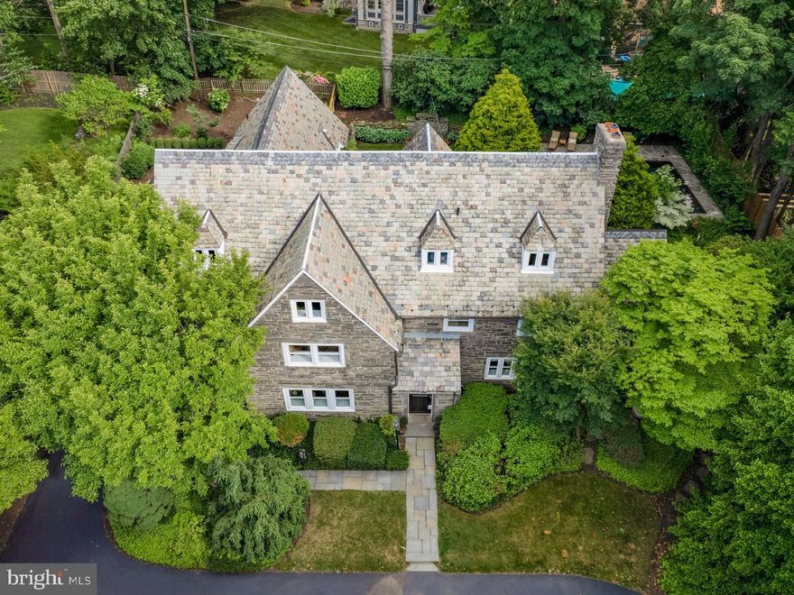 Who says you can’t have it all? You must see this turn-key, walkable, Merion Station masterpiece that checks nearly every conceivable box on your ‘wish-list’.  This grand, updated, and impeccably maintained Stone Classic will not disappoint.  With hardwood throughout, this tastefully renovated home boasts nearly 6,000 square feet of luxurious interior living space, plus a private pool oasis in the gorgeous, fenced, rear yard.  Enter from your circular driveway into the bright first floor foyer, flanked by incredible living spaces that include a large living room with wood-burning fireplace, and an enormous formal dining room, complete with vintage paneling. Enjoy a chef’s dream eat-in kitchen with commercial-quality stainless steel appliances, expansive granite counters, an oversized wrap-around island, double-oven, double-dishwasher, walk-in pantry, breakfast area, and even sparkling water on tap.   This floor provides multiple exterior access points, including the mudroom which leads to the parking area and garage, the private screened-in dining porch, and the beautifully charming landscaped and hardscaped stone patio and rear yard.  The 2nd floor includes a primary suite, complete with plantation shutters, walk-in closets, wood burning fireplace, and a renovated bathroom with radiant floors.  As well, you’ll find the private in-law suite (for families that really love their in-laws) that includes dedicated stairwell access, a renovated bathroom (radiant floors, jacuzzi, steam shower), and laundry room. Another 2 large bedrooms with an en-suite bath and a den/bonus room complete the floor. The 3rd level includes 2 even larger bedrooms, another full bath, additional attic storage, and a cedar closet.  Endless expansion possibilities with the unfinished full basement (w/ walkout door) where you’ll find the temperature-controlled wine cellar.   This home comes complete with a fully slate roof, whole house generator, Tesla EV charger, 400 amp service, and did I mention low taxes? Situated in award-winning Lower Merion School District, within easy walking distance (under 15 minutes) to Merion Station, Narberth, and Wynnewood train stations, and just a stone’s throw from Merion Elementary (w/ it’s fields and playgrounds), it’s hard to find a reason not to love this location.  **Pre-Inspection, virtual walk-through, and floor-plan are all available**