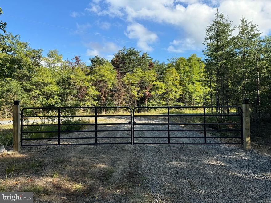 Discover your own slice of serenity in the sought-after, wild and wonderful, Ashton Woods community with this incredible 20.62 acre wooded property. Ideally situated just 3/4 of a mile off Corridor H, this private retreat sits securely behind gated access in a prestigious 10,000 acre mountain community - where all properties are 20 or more acres, blending convenience with tranquility.

The land offers a spacious, cleared, flat building site ready for your dream home or weekend escape, complete with a convenient circular driveway featuring two brand new gates and an existing water well (just add a pump). Explore scenic hiking trails winding through lush hardwoods and pines, enjoy evenings around the established fire ring, and take in the calming presence of a seasonal mountain creek.

Bring your plans for hunting, recreational shooting, and enjoying abundant wildlife - plenty of deer activity has been observed, with large bucks roaming these hills - enjoy camping, or even raising livestock - it's all permitted here. The HOA is friendly to rural lifestyles, though commercial businesses are not allowed, preserving the area's peaceful character.

With approximately $30,000 worth of essential infrastructure already completed, including fiber internet availability, power access, and a successful perc test, you’re just a step away from having everything fully functional. An estimated additional investment of around $15,000 can quickly finalize septic installation, electrical connections, and the water pump for the well - making the site perfect for immediate RV use or construction on your forever home.

This prime location puts you just 5 minutes from the conveniences of Moorefield - shopping, dining, schools, Walmart, and entertainment. Nature lovers and outdoor adventurers will appreciate proximity to South Branch Potomac River access points (only 10 minutes away), world-class trout fishing and vast George Washington National Forest lands (30 minutes), and ski resorts (40 minutes).

Additionally, residents enjoy exclusive community access to the neighboring Nathaniel Mountain Wildlife Management Area - over 10,000 acres dedicated to public hunting and hiking.

All of this awaits within an easy and picturesque 55 minute drive from Northern Virginia. Your perfect blend of country living, convenience, and outdoor adventure awaits, here in Ashton Woods.