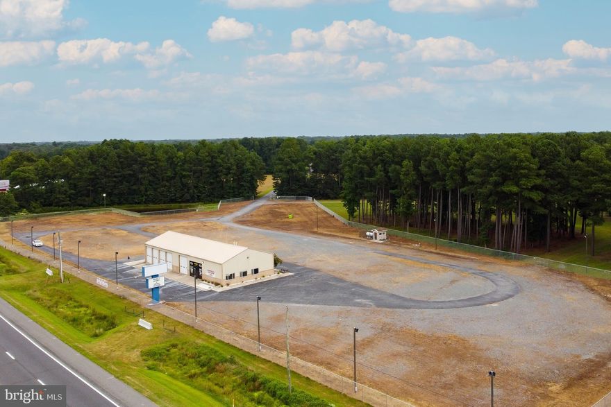 PRIME COMMERCIAL PROPERTY! Boasting an impressive 1,260 feet of high visibility frontage along Rt. 13, this property spans over 26 acres with both C-1 and GR zoning. Revel in the contemporary 4,000 sq ft metal structure, currently outfitted as a showroom/shop complete with 2 bathrooms, multiple offices, open retail space, 5 garage doors and high ceiling clearance . This large parcel is your blank canvas for your next enterprise. Dive into endless possibilities! (Note: business not part of the offering).