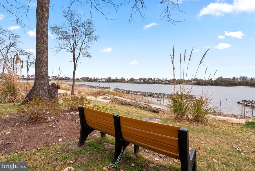 ALERT:  PRICE DROP! Welcome Home to this beautifully maintained townhome in the sought-after Stoney Beach community! Perfectly situated just steps from Stoney Creek, this home offers amazing water views and an easy, coastal lifestyle. This spacious three-level residence features 3 bedrooms, 2 full baths, and 2 half baths. The main level welcomes you with gleaming hardwood floors and an open-concept layout that seamlessly connects the living room, dining area, and kitchen. Just off the kitchen, enjoy a private deck—ideal for relaxing or entertaining while taking in the surrounding scenery. Upstairs, the spacious primary suite boasts vaulted ceilings, a walk-in closet, en-suite bath, and stunning water views. Two additional bedrooms and a full hall bath complete the upper level. The finished lower level provides even more living space with a cozy family room, warming fireplace, half bath, laundry area, storage space, and a bonus room—perfect for an office, workout space, or guest area. Stoney Beach offers an impressive list of amenities including tennis/basketball courts, a community pool, tot lot, dog park, boardwalk, beach, boat ramp, and pier—living here feels like being on vacation every day. All of this, just minutes to major highways, commuter routes, and a variety of dining and shopping options. Don't miss the chance to make this waterfront community your home!