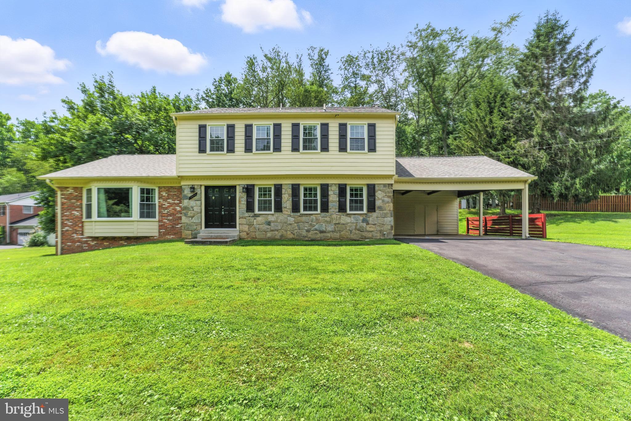 Classic stone-front Colonial on gorgeous private lot on quiet dead-end street in beautiful Drumeldra Hills! Spacious formal living and dining rooms with hardwood floors are flooded with natural light, convenient first-floor office/bedroom with adjacent half bath and large kitchen/breakfast room opens to the warm & inviting family room with stone hearth wood-burning fireplace! Top level features four bedrooms with hardwood floors and generous closet space and two full baths including the primary suite with private bath and walk-in closet. Full lower level includes a large finished family room/rec room area with side exit and huge workshop/storage/laundry area. Two-car carport with built-in shed and loads of off-street parking. Recent updates include double-pane windows throughout, architectural shingle roof and electrical heavy-up! This home represents a real value in a beautiful private setting - don't miss it!